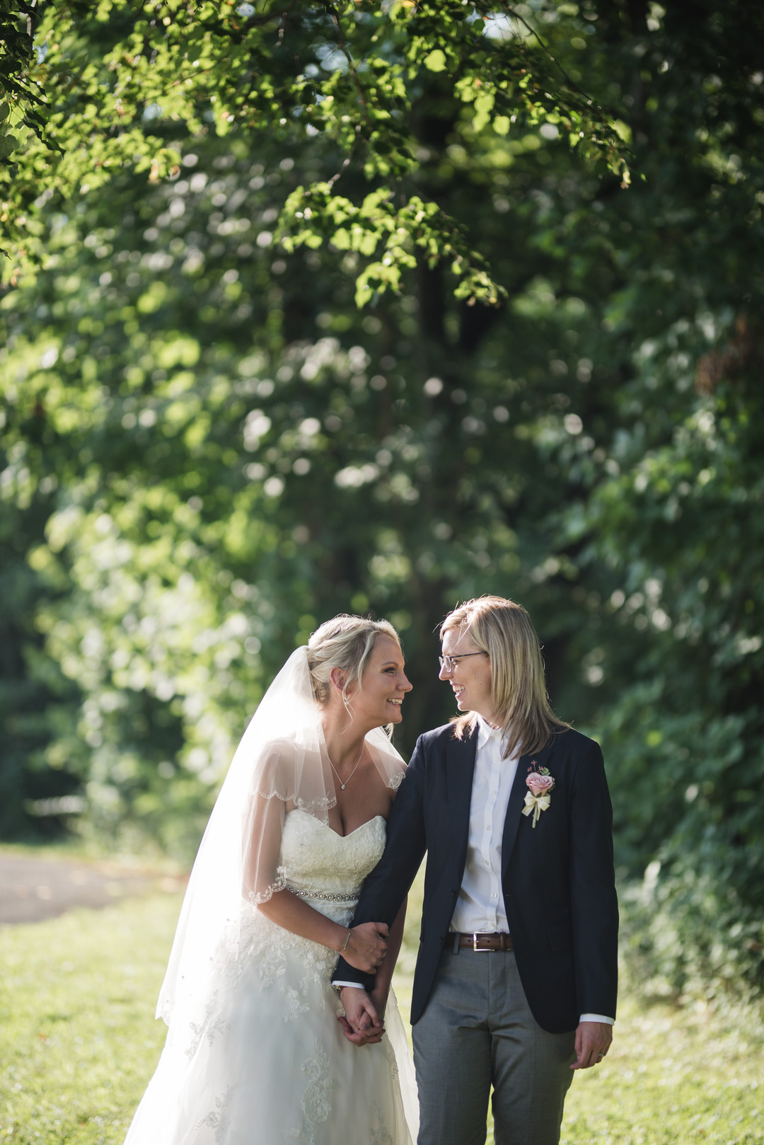 Rustic wedding in Columbus, Ohio two brides long white dress black suit outside trees nature