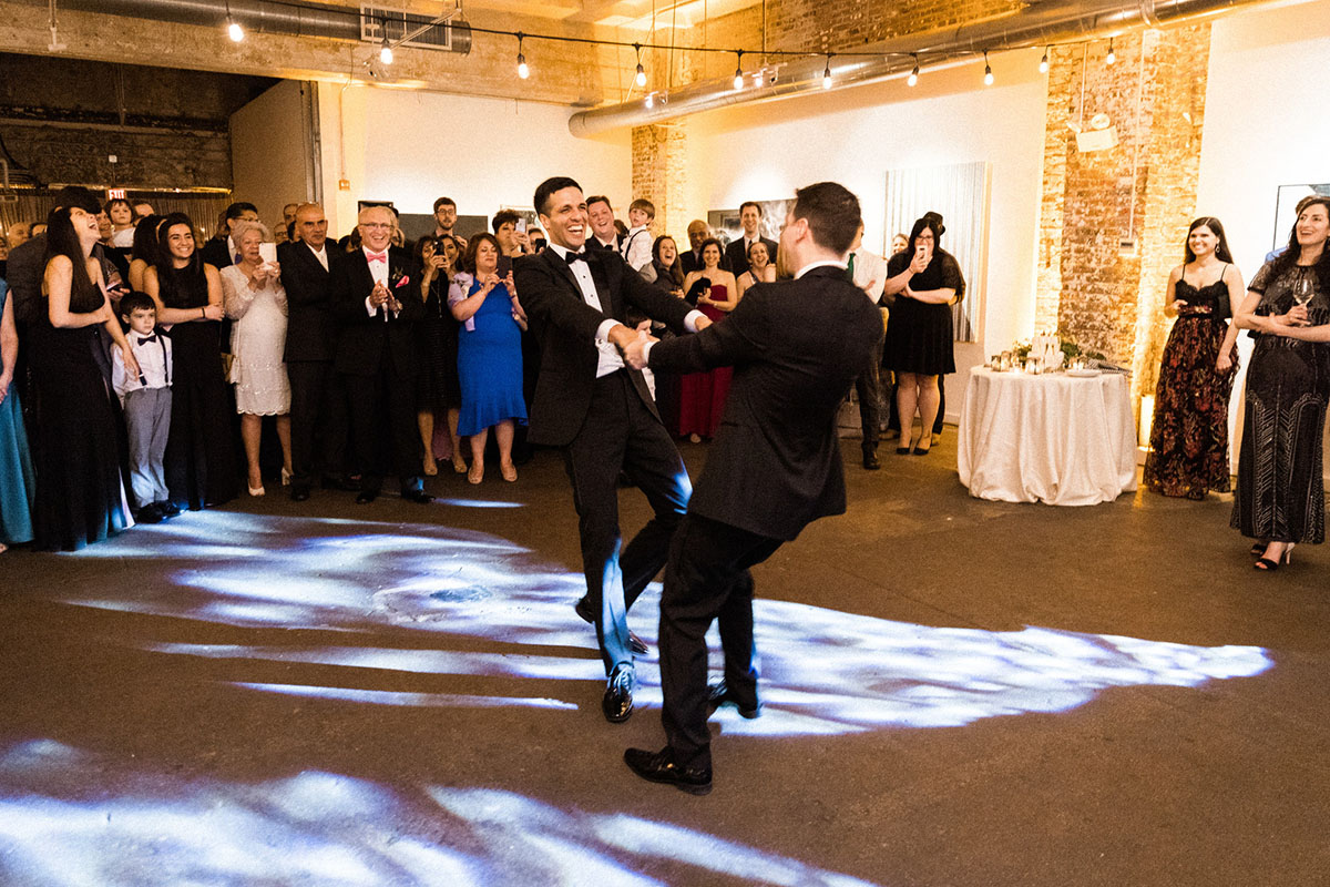 Energetic, colorful wedding in Washington, D.C. two grooms bow ties black tuxedos first dance