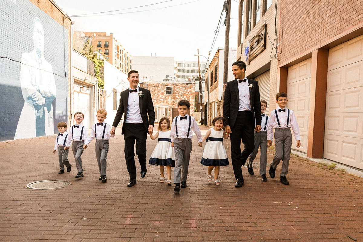 Energetic, colorful wedding in Washington, D.C. two grooms bow ties black tuxedos little attendants