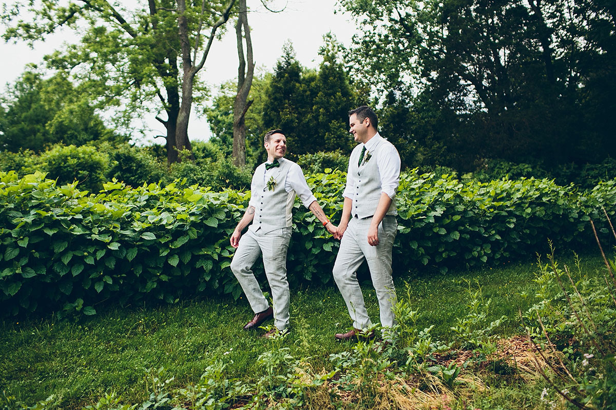 Flower farm wedding with s'mores bar two grooms gay queer wedding elopement grey suits matching green bow ties