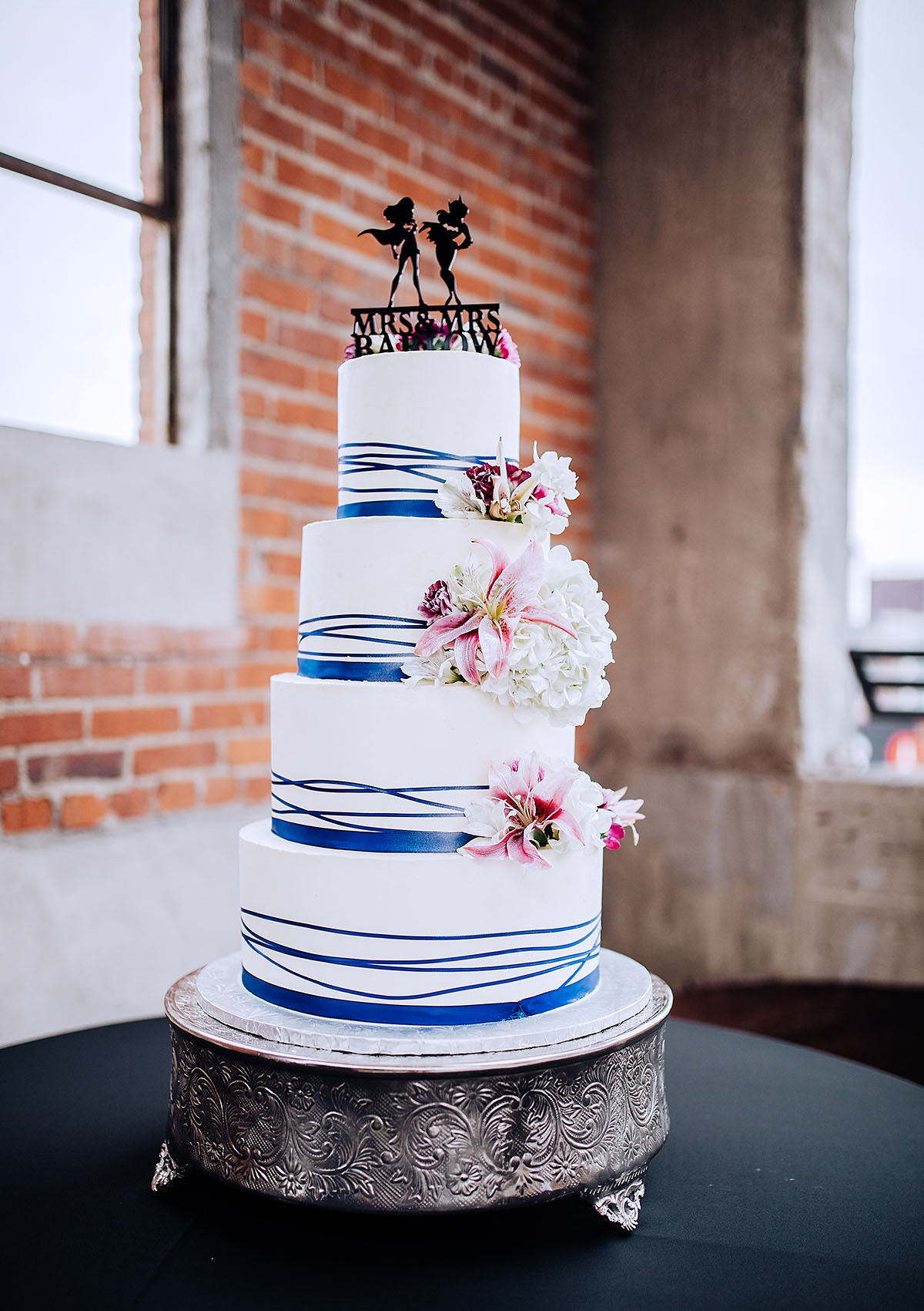 Modern rooftop wedding in Kansas City, Kansas striped blue floral cake super heroes superwoman