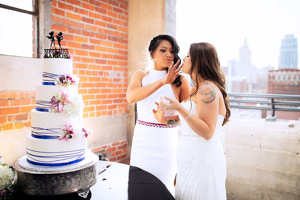 Modern rooftop wedding in Kansas City, Kansas Asian-American lesbian wedding long white dresses cake