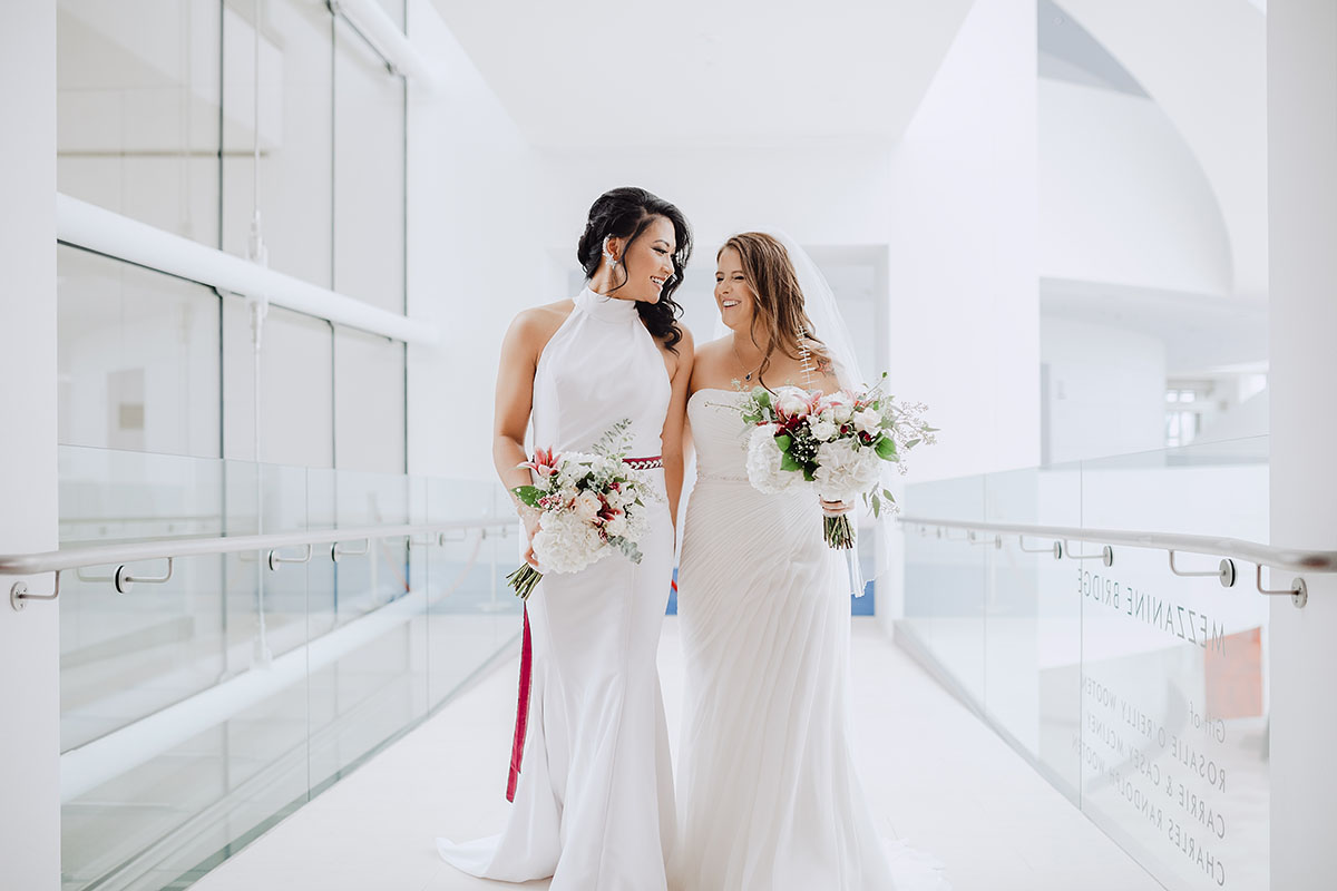 Modern rooftop wedding in Kansas City, Kansas Asian-American lesbian wedding long white dresses