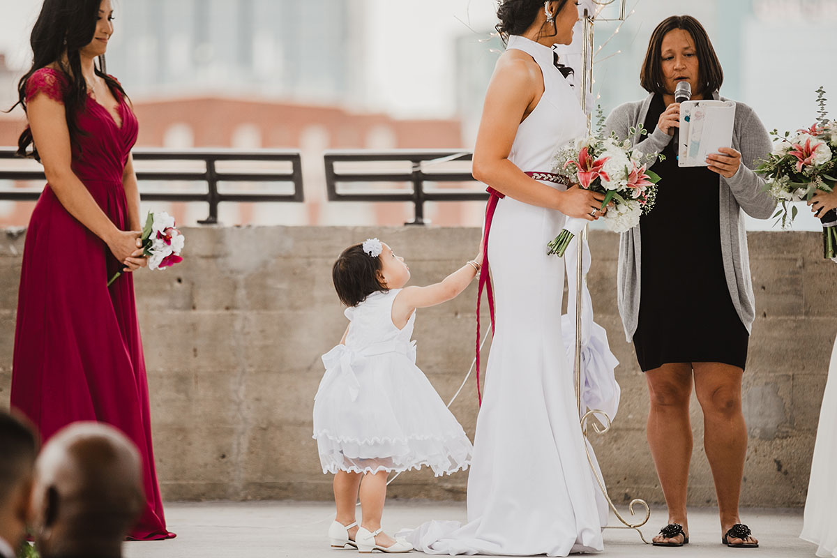 Modern rooftop wedding in Kansas City, Kansas Asian-American lesbian wedding long white dresses vows child
