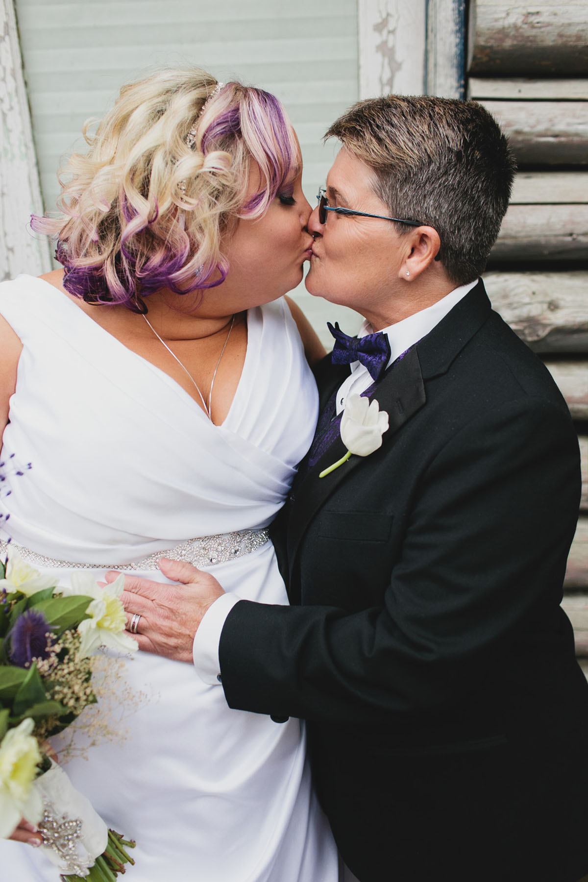 Purple greenhouse wedding with goats two brides lesbian wedding black tuxedo white dress