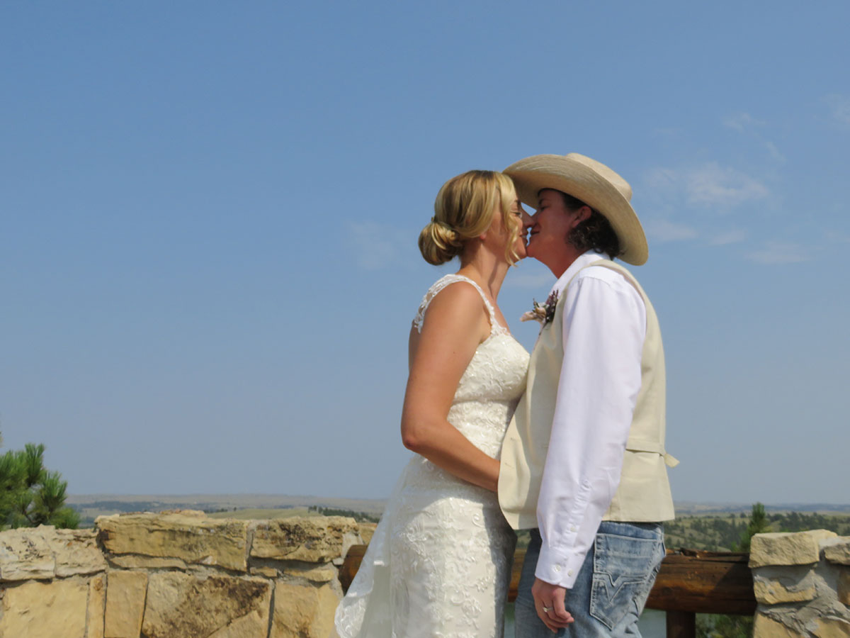 Rustic castle wedding at Guernsey State Park in Wyoming white lace dress cowboy hat intimate wedding