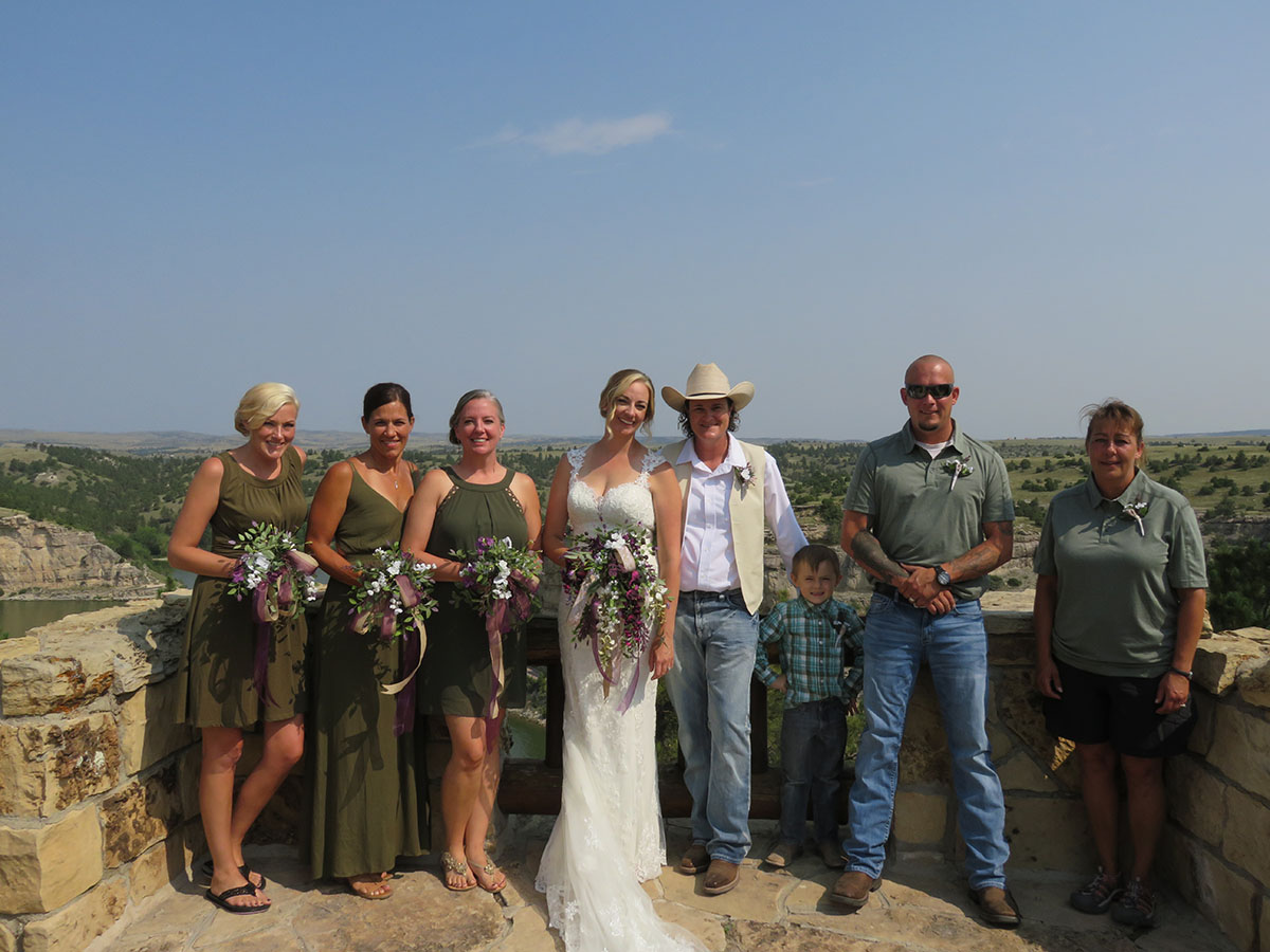Rustic castle wedding at Guernsey State Park in Wyoming white lace dress cowboy hat intimate wedding green wedding party