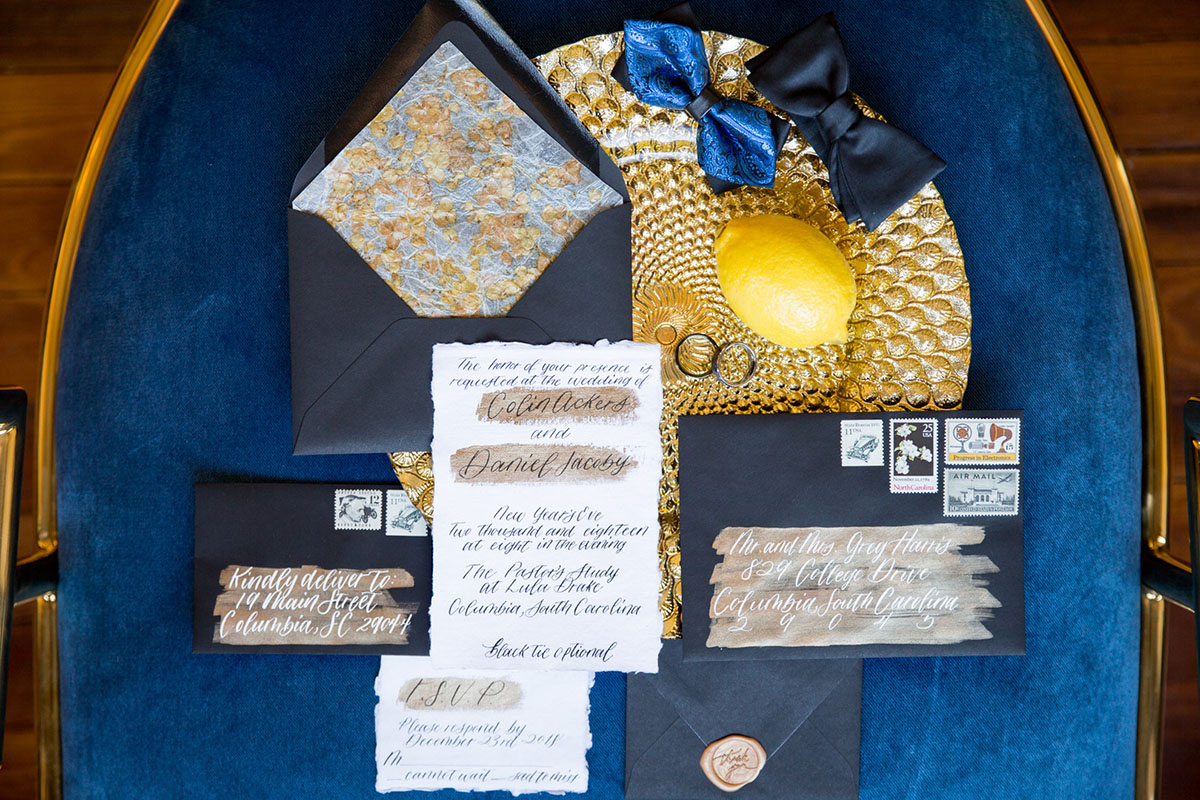 Blue and gold New Year's Eve elopement inspiration luxurious opulent all black party navy invitations wedding rings bow ties stationery rustic southern