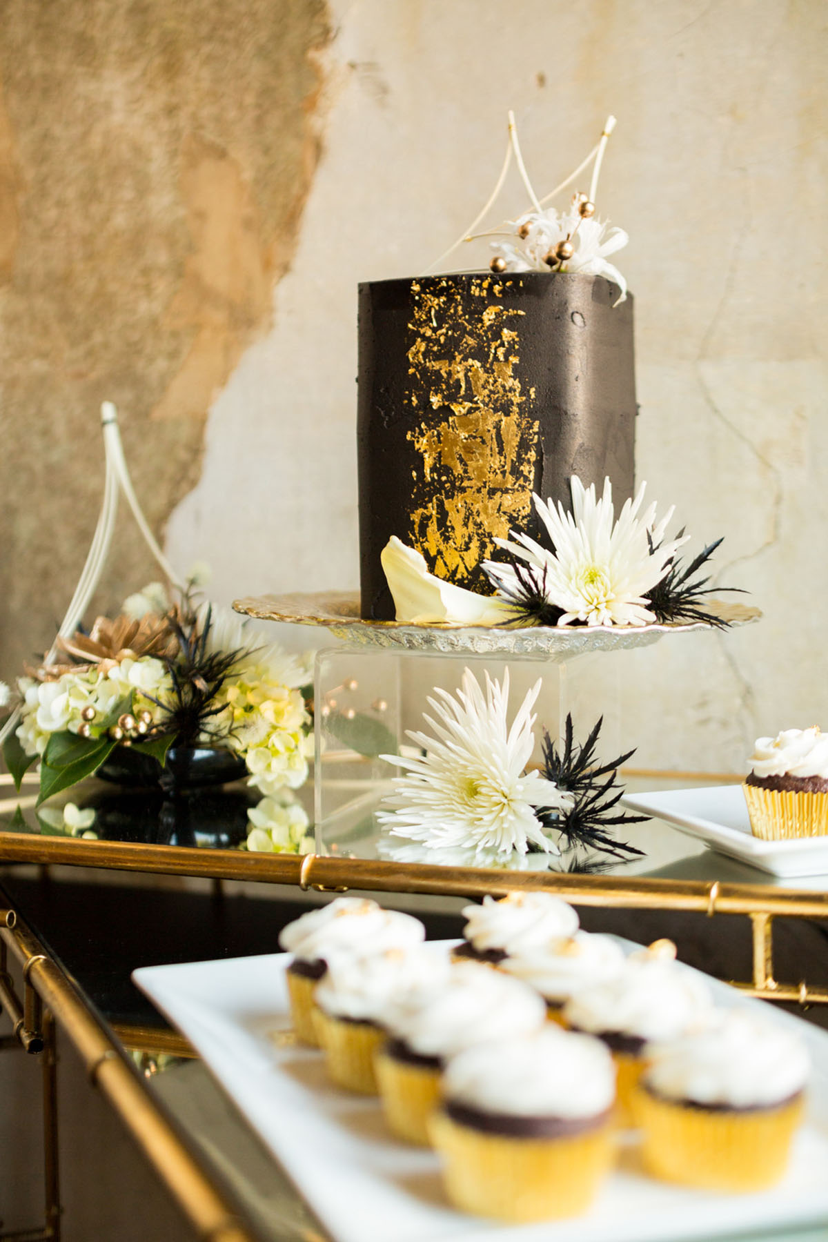 Blue and gold New Year's Eve elopement inspiration cupcakes dessert table black matte gold foil cake