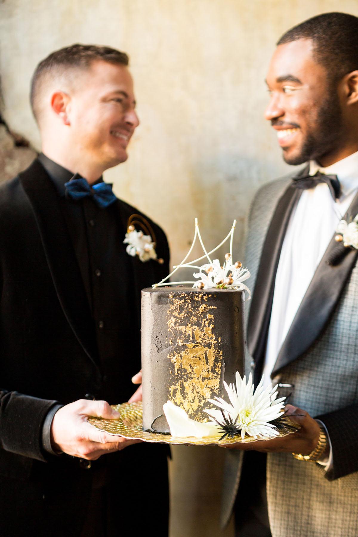 Blue and gold New Year's Eve elopement inspiration all black party black tuxedos two grooms bow ties black matte gold foil cake