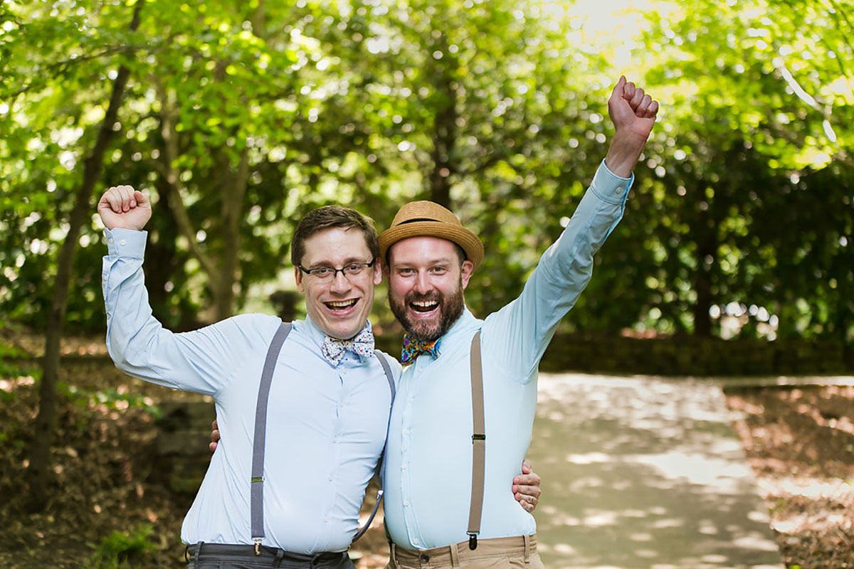 Casual outdoor wedding at the Garden Club of Georgia two grooms suspenders colorful bow ties fun eclectic