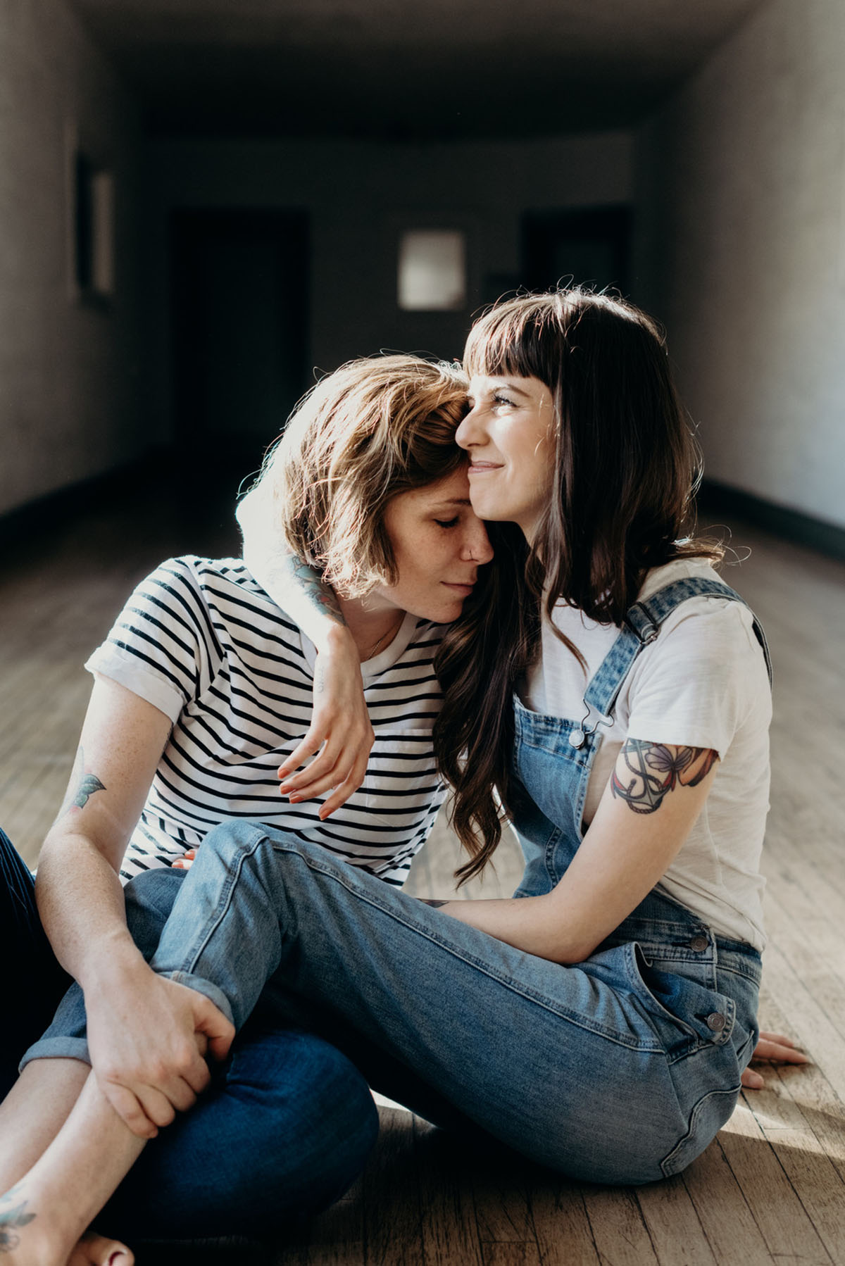 Home engagement photos with cats in San Diego, California two brides lesbian couple overalls plants rooftop garden tabby tuxedo cat tattoos intimate casual