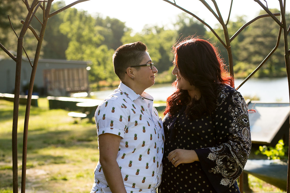 Outdoor engagement session in Pine Lake, Georgia two brides pineapple shirt glasses short hair burgundy hair