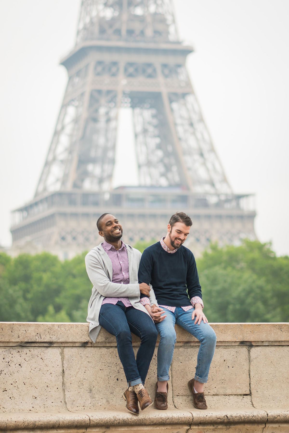 Proposal in front of the Eiffel Tower in Paris, France two grooms gay engagement surprise bridge