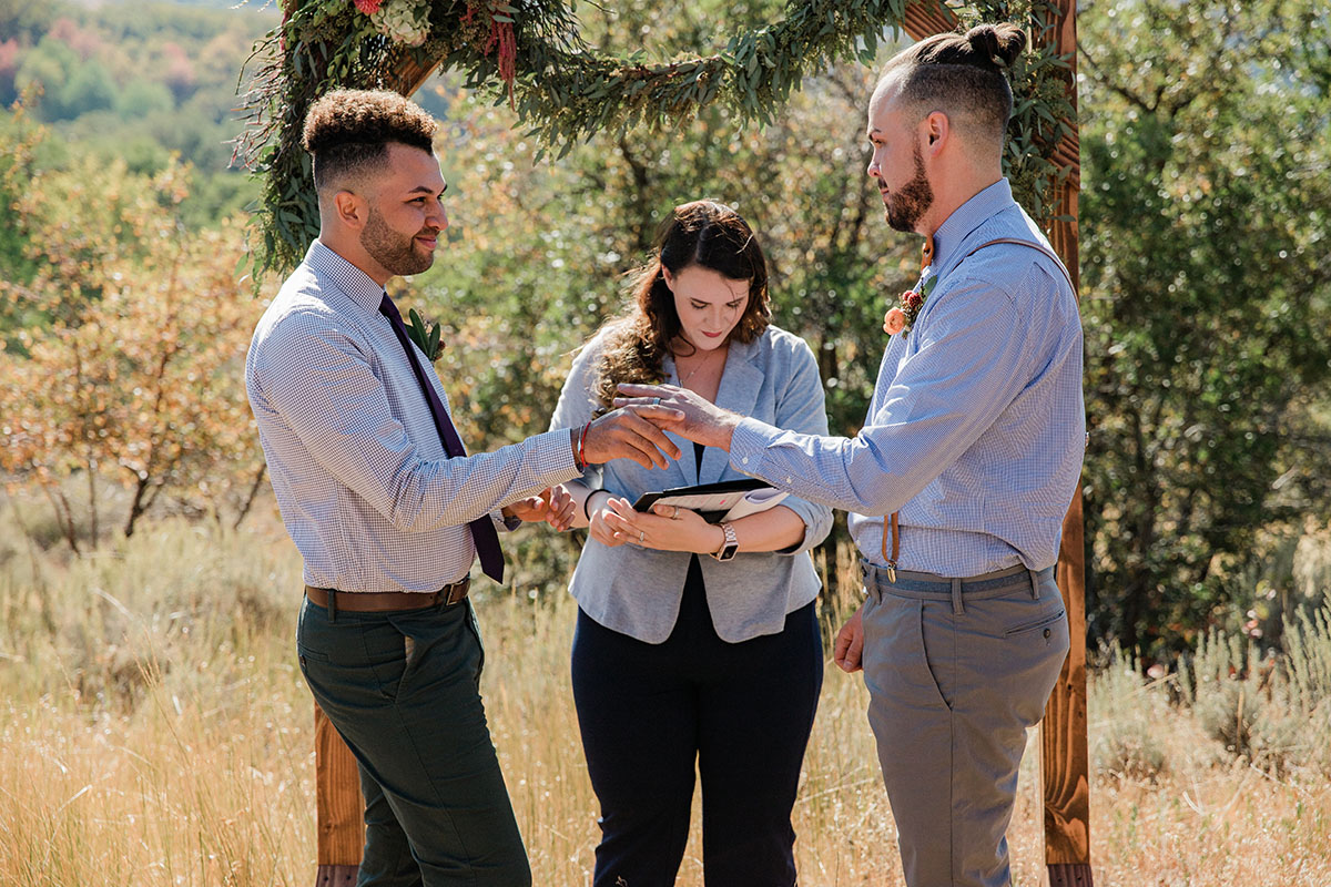 Rustic mountain wedding at the Art Nord Trailhead two grooms suspenders bow tie Syracuse, Utah short ponytail vows