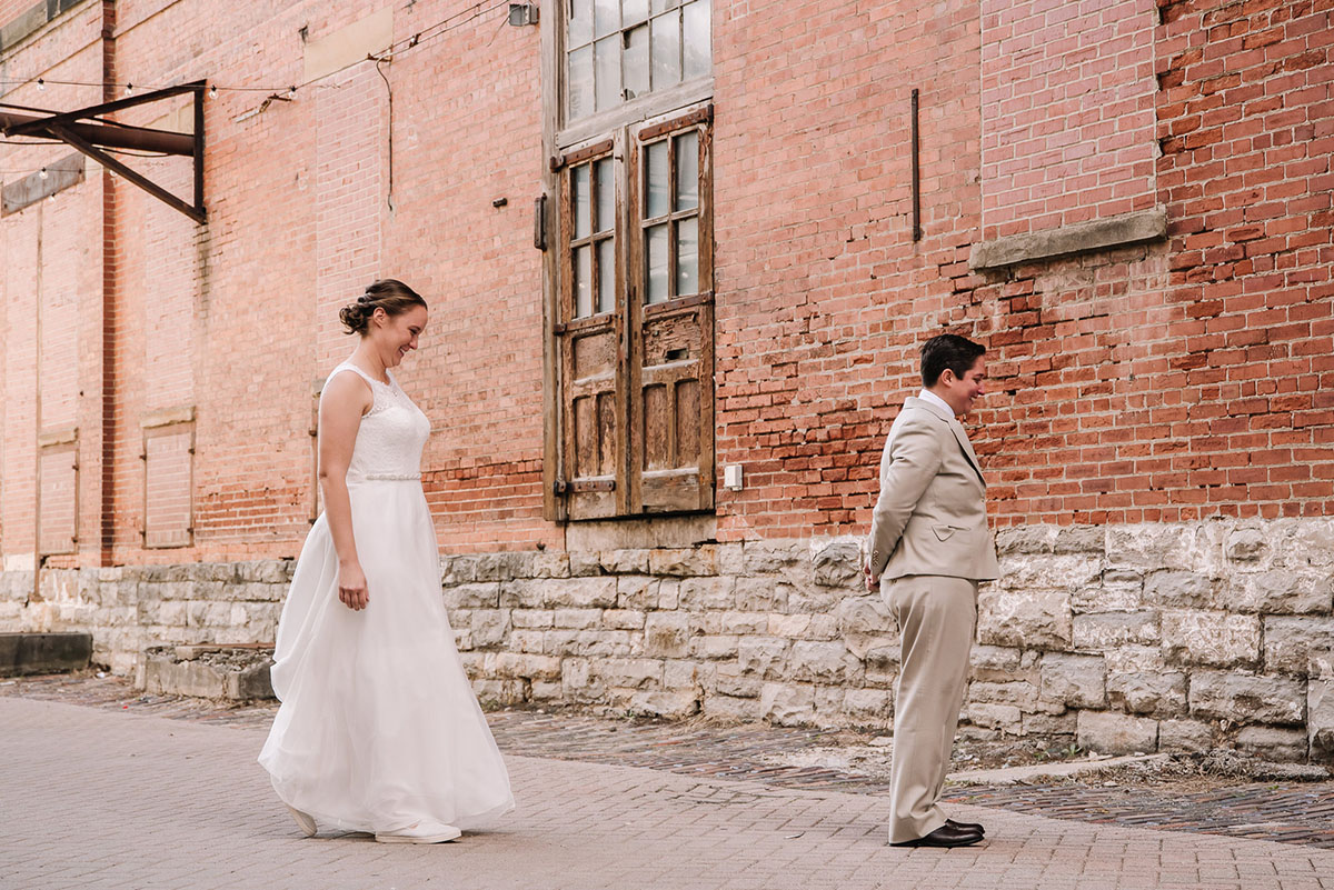Rustic winery wedding in Columbus, Ohio exposed brick grey tuxedo long white tulle dress two brides first look