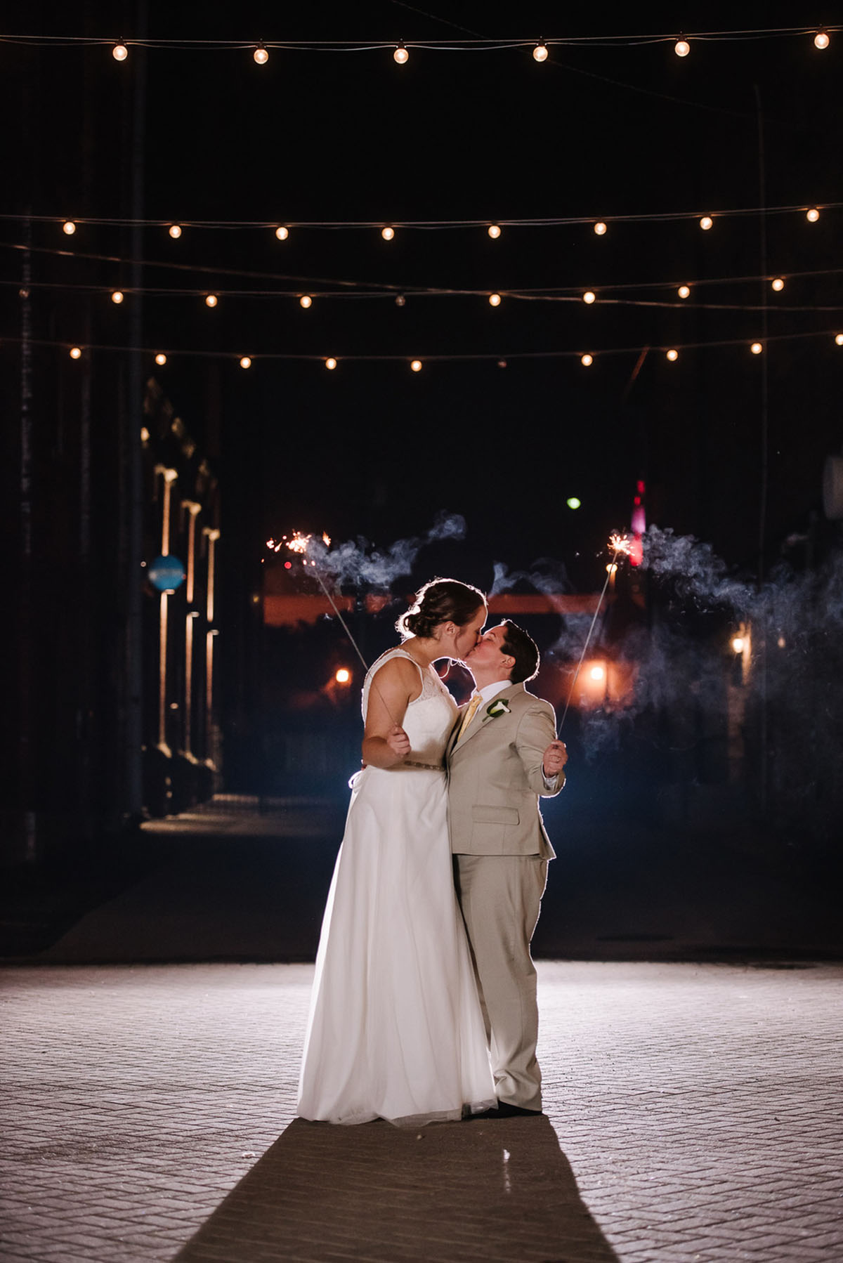 Rustic winery wedding in Columbus, Ohio exposed brick grey tuxedo long white tulle dress two brides sparkler