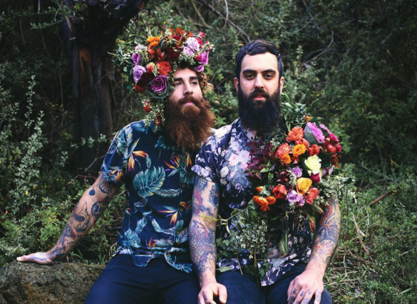22 couples with tattoos that prove ink is the best wedding look two bearded men with sleeve tattoos and colorful flowers