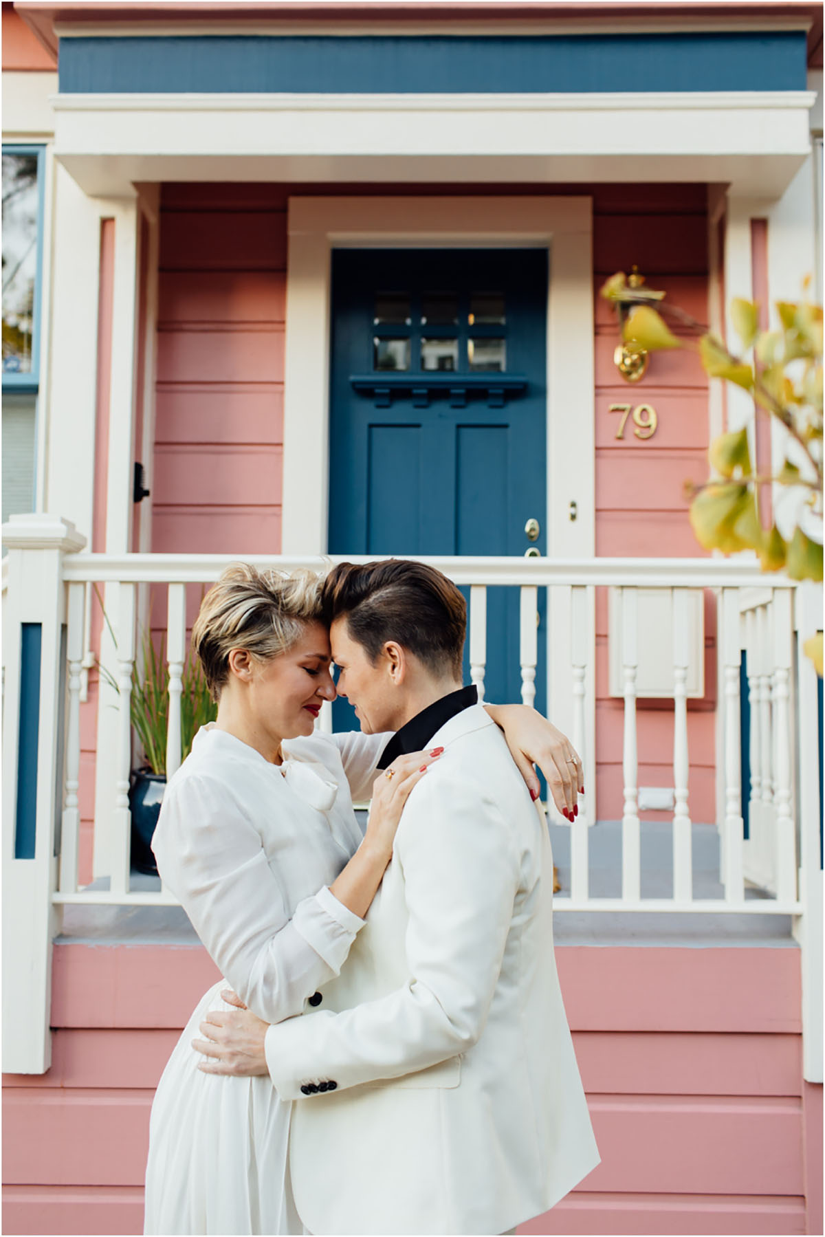 Stylish San Francisco, California, engagement tea length white dress short hair white tuxedo high heels pink house porch