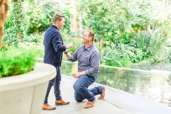 Surprise proposal at Longwood Gardens two grooms champagne Pennsylvania Kennett Square engagement
