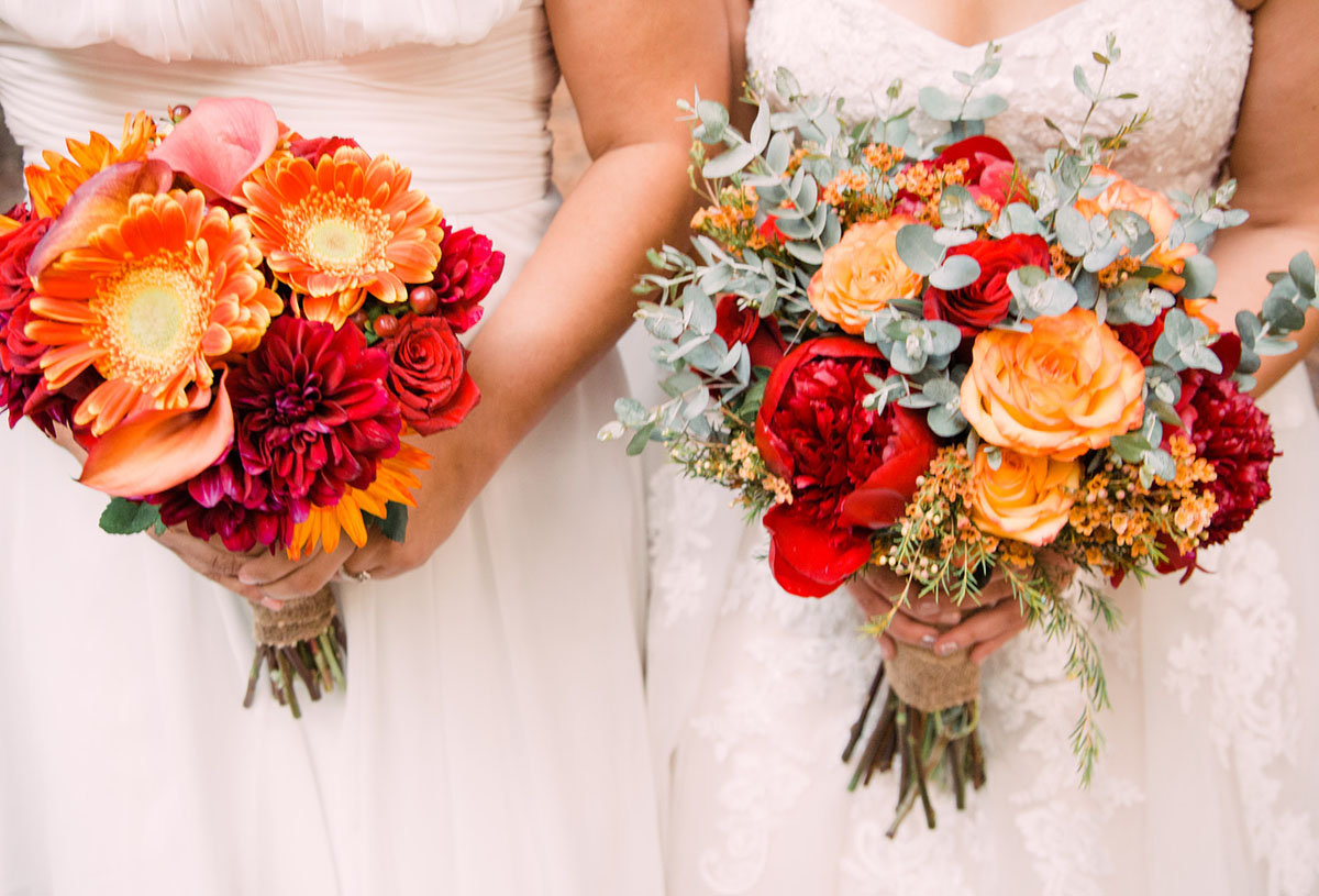 This couple got married in San Francisco during the California wildfires two brides breast cancer survivor white lace dresses red orange bouquets