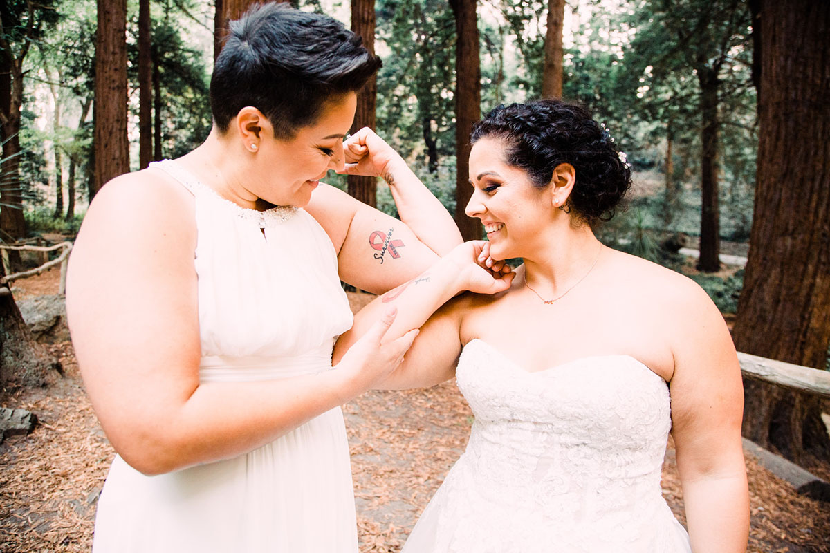 This couple got married in San Francisco during the California wildfires two brides breast cancer survivor white lace dresses tattoo
