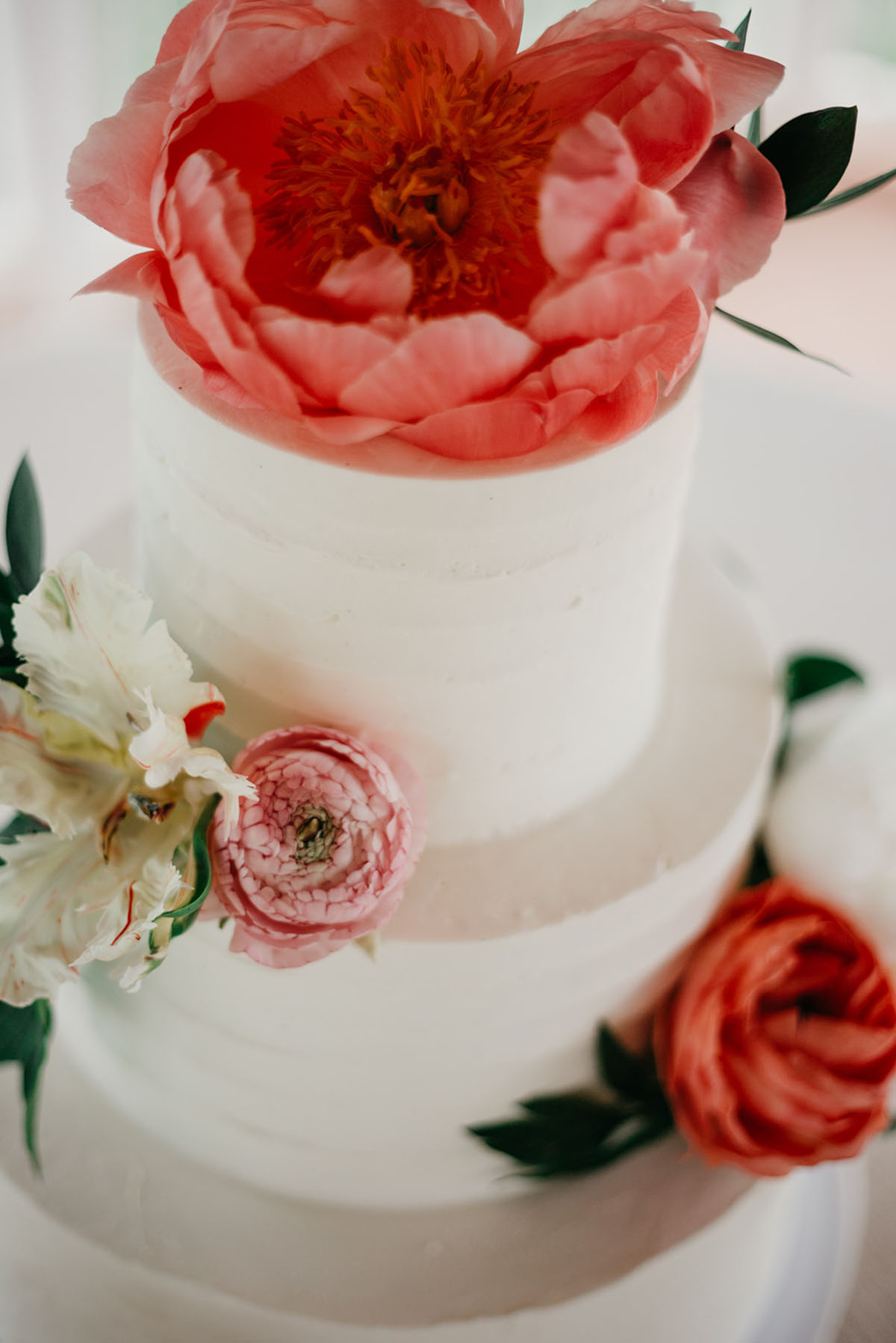Vintage, romantic vineyard wedding two brides lesbian updos buns white dresses pearls red flower cake
