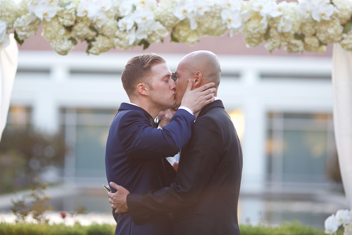You'll want to a be a guest at this couple's Beauty and the Beast inspired wedding two grooms tuxedos tuxes just married kiss