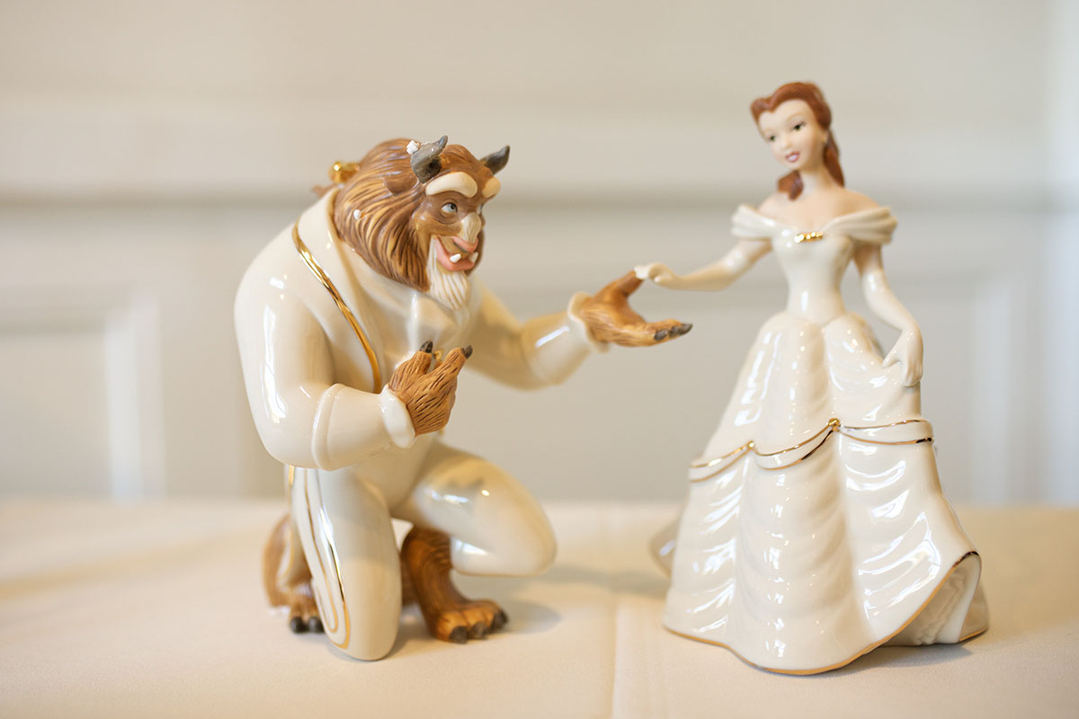 You'll want to a be a guest at this couple's Beauty and the Beast inspired wedding Beast Belle figurines