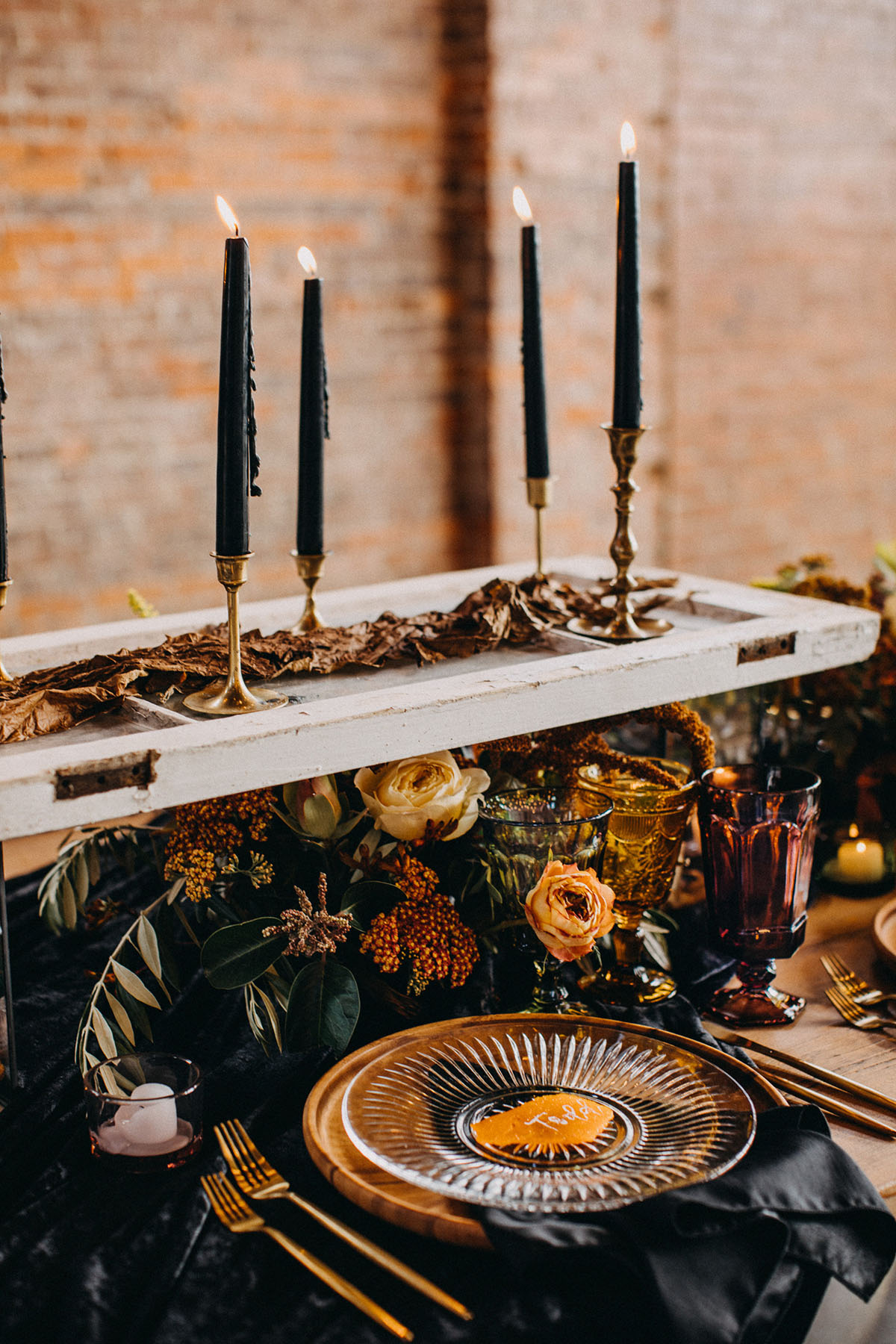 Earthy winter wedding inspiration table setting flowers black candles