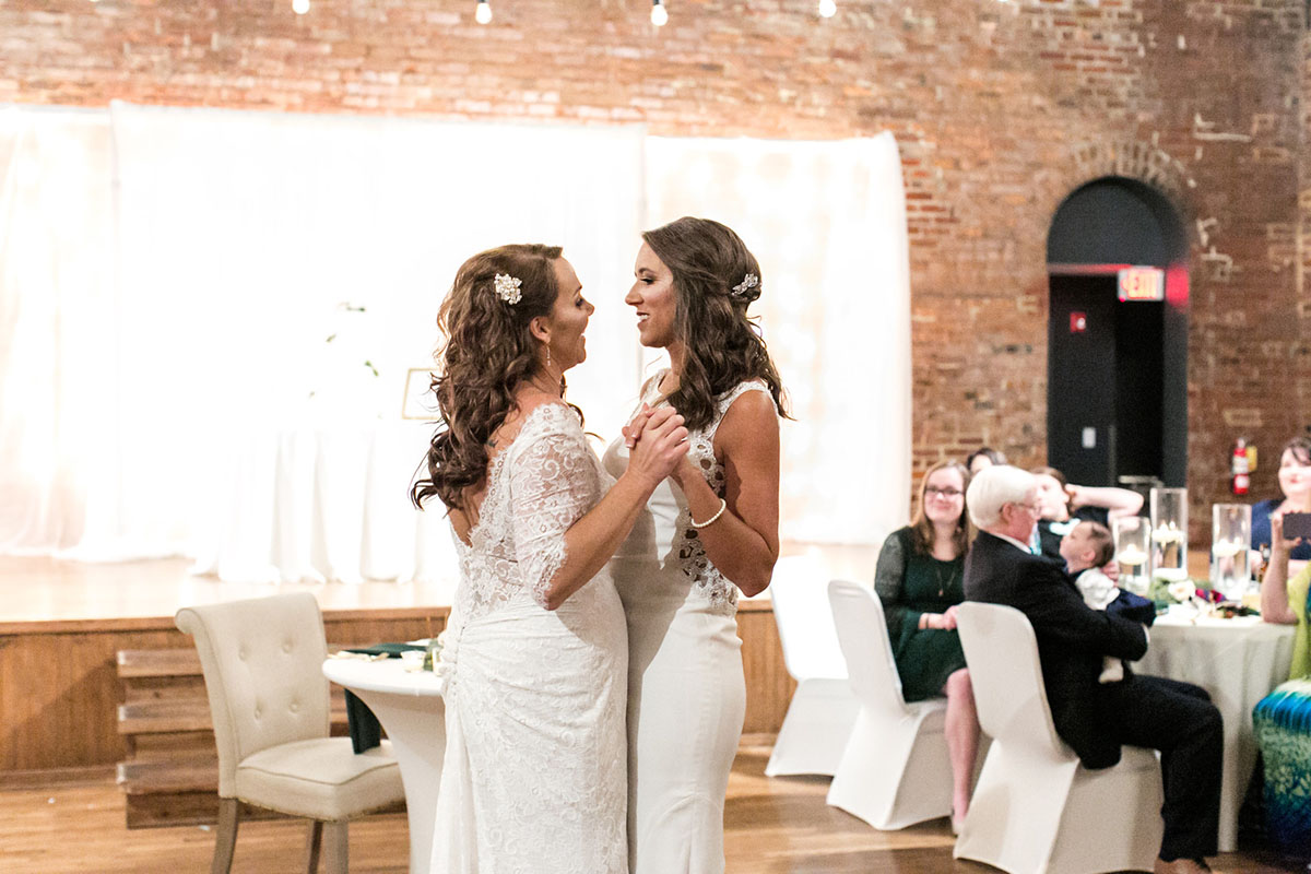 Elegant church wedding in Chattanooga, Tennessee two brides long white lace traditional dresses fairy lights