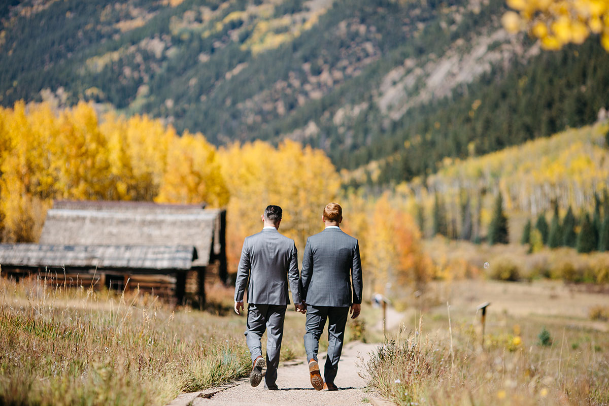 Fall mountain wedding in Aspen, Colorado two grooms steel grey tuxedos patterned ties foliage