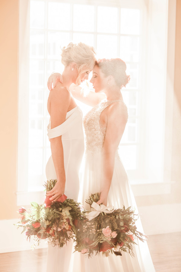 Historic mansion winter wedding inspiration two brides long white dresses up do