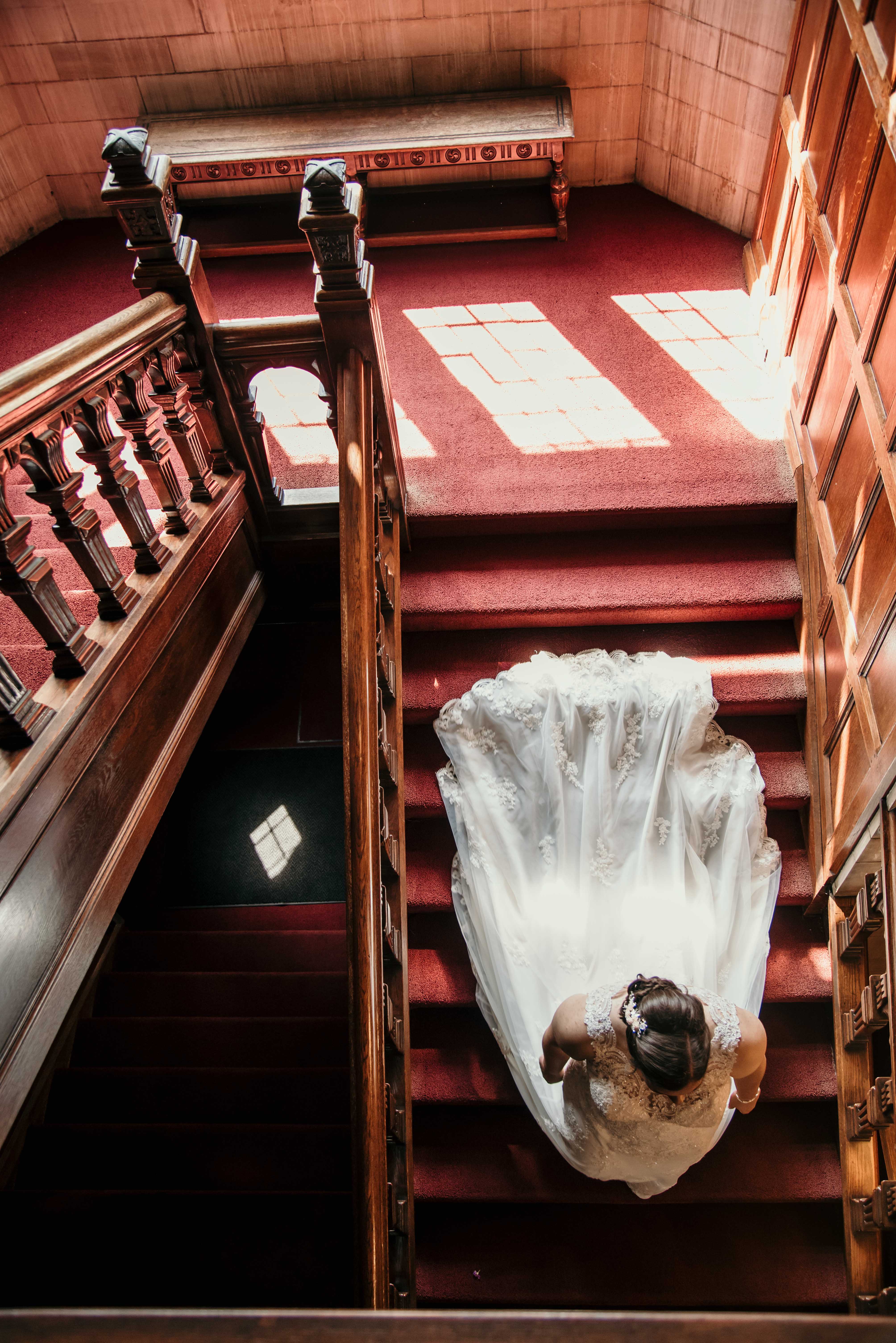Purple summer wedding in Pittsburgh, Pennsylvania two brides long white dresses bouquets staircase
