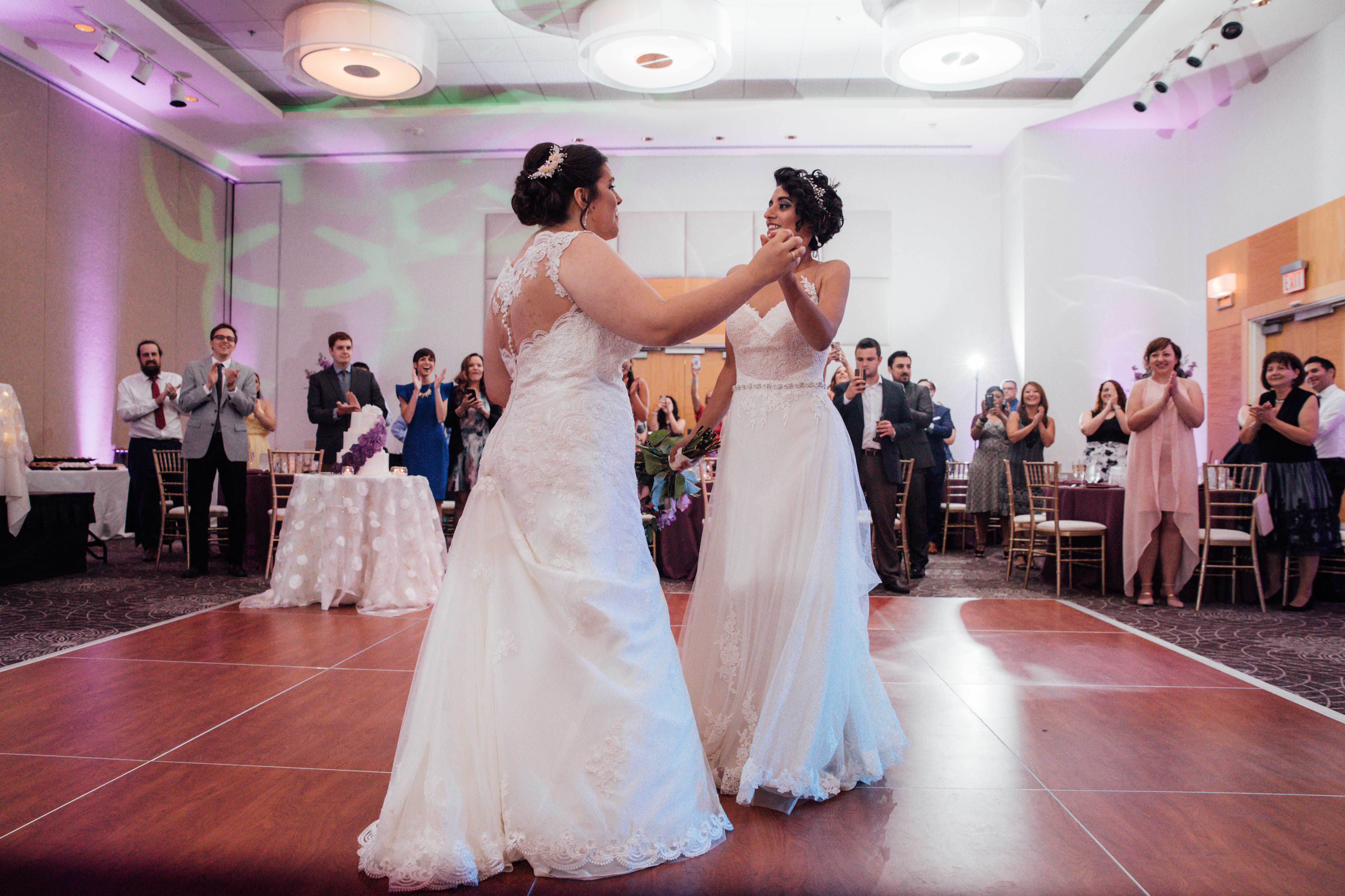 Purple summer wedding in Pittsburgh, Pennsylvania two brides long white dresses bouquets first dance