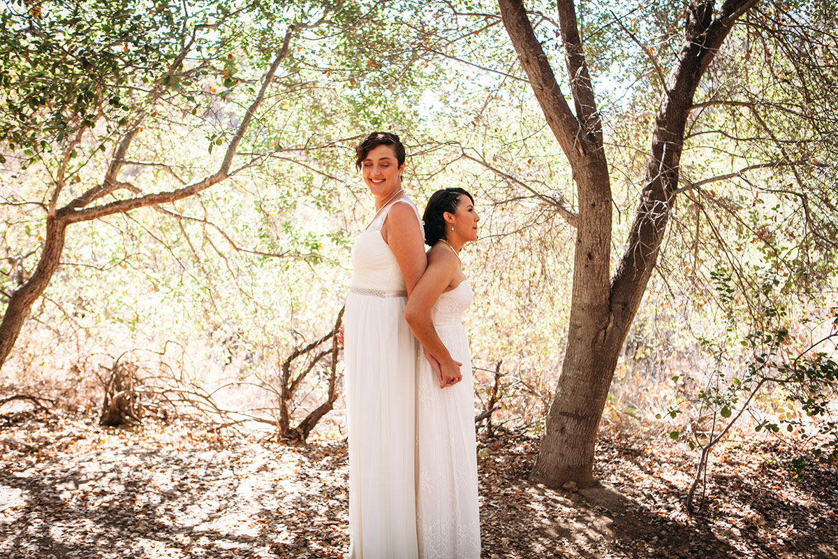 Purple wedding at Mission Trails Regional Park two brides BHLDN David's Bridal white dresses nature outdoors first look