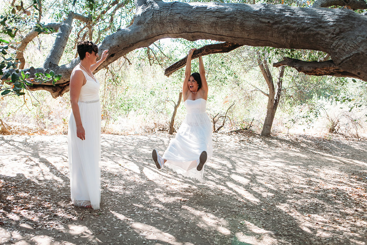 Purple wedding at Mission Trails Regional Park two brides BHLDN David's Bridal white dresses nature outdoors swing