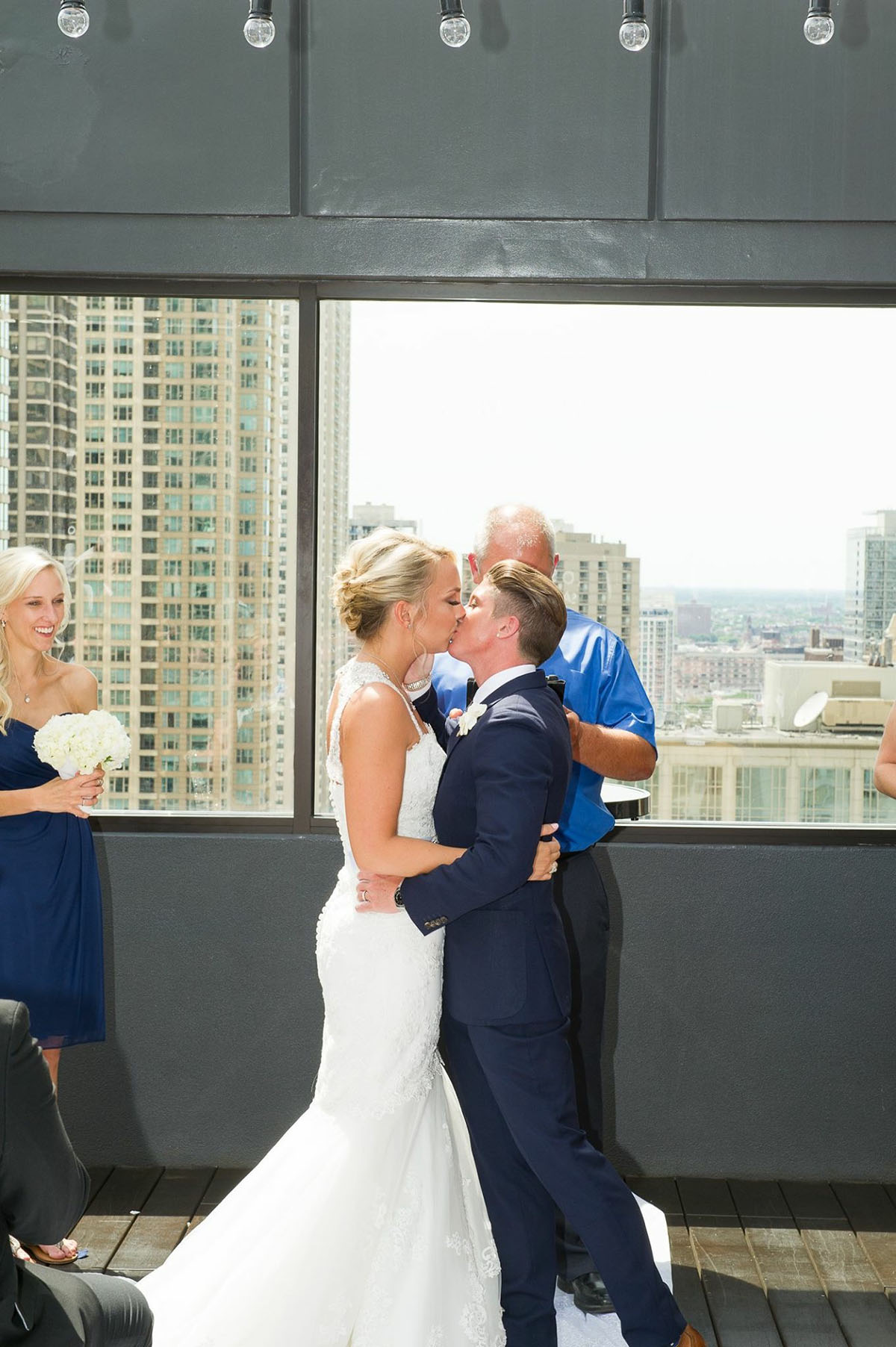 Rooftop wedding in downtown Chicago, Illinois two brides mermaid white dress tuxedo custom suit