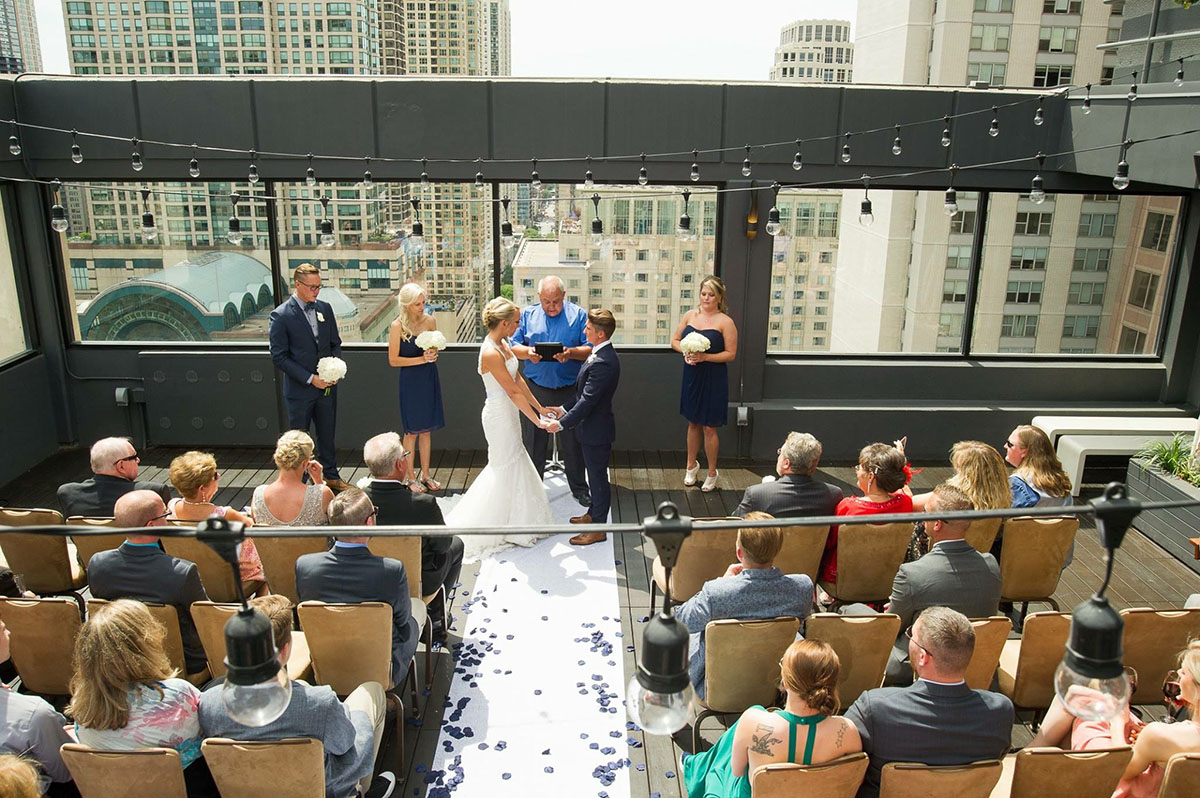 Rooftop wedding in downtown Chicago, Illinois two brides mermaid white dress tuxedo custom suit