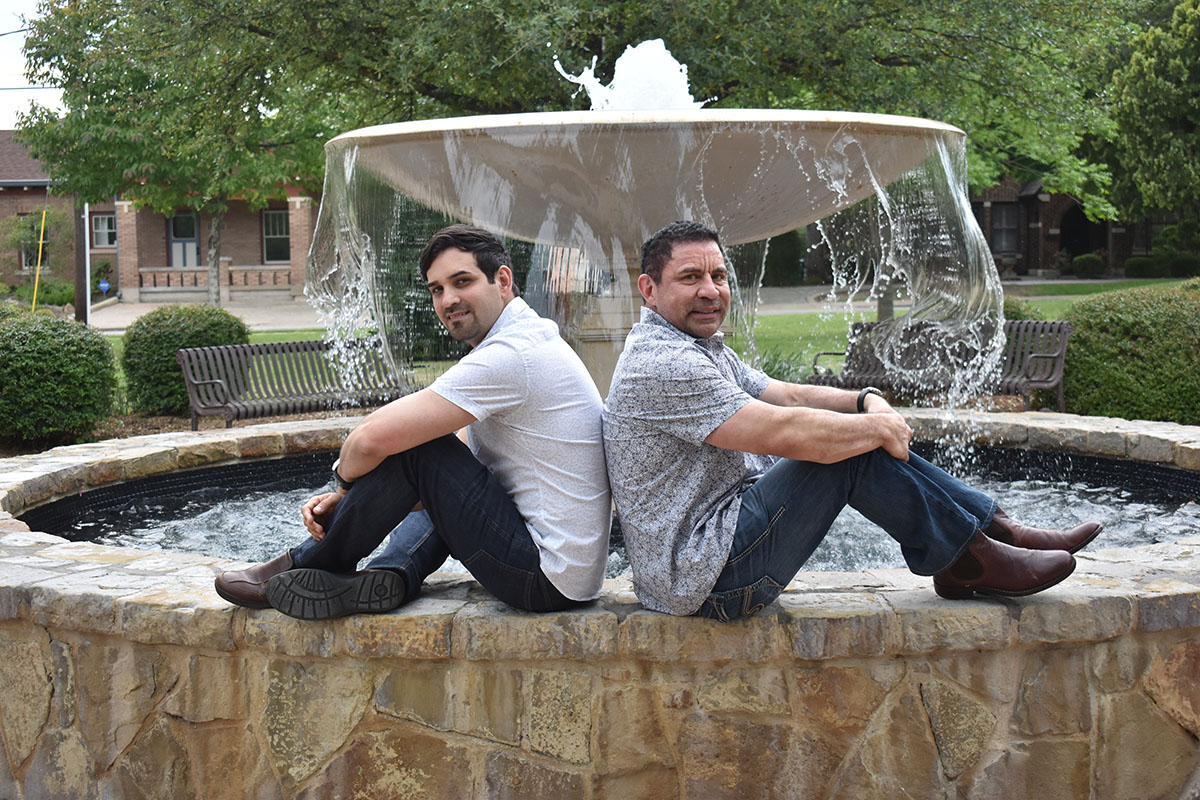 Engagement photos in historic McKinney, Texas two grooms downtown casual fountain