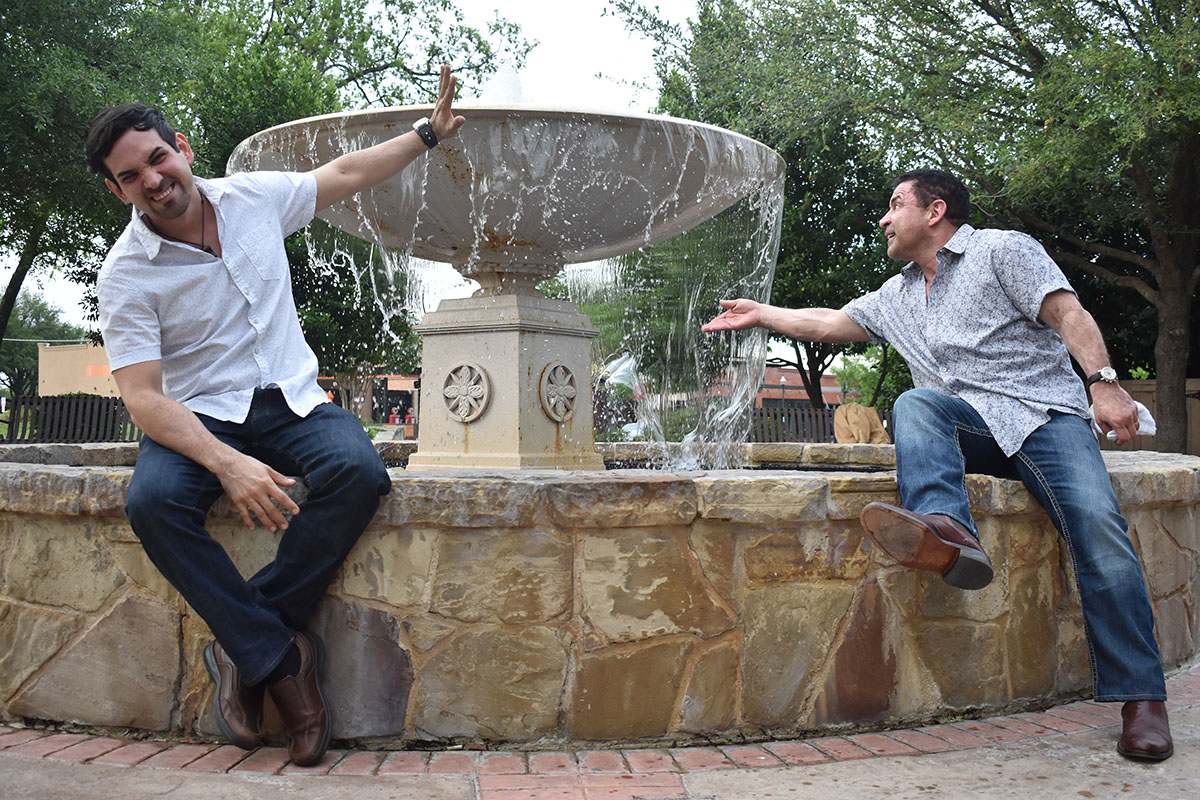 Engagement photos in historic McKinney, Texas two grooms downtown casual fountain