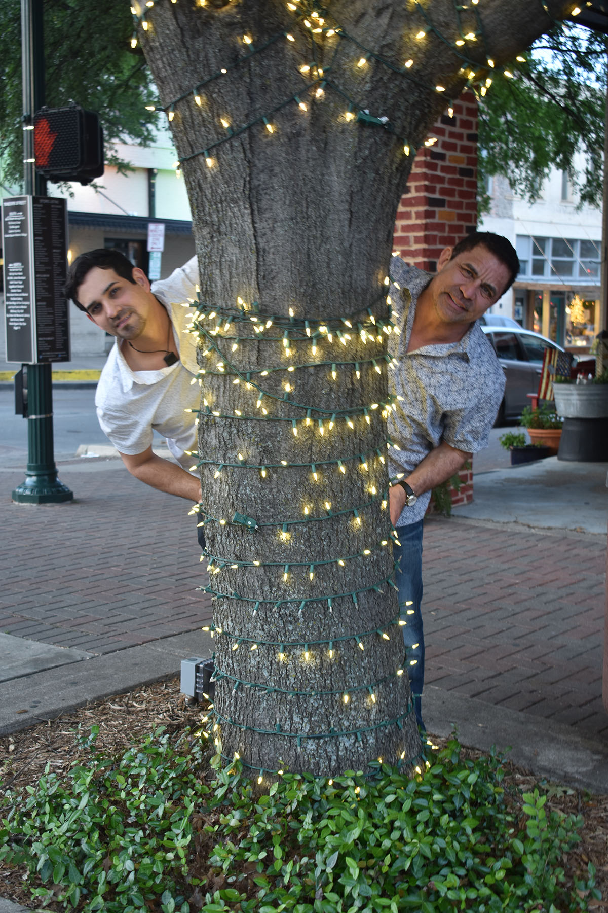 Engagement photos in historic McKinney, Texas two grooms downtown casual