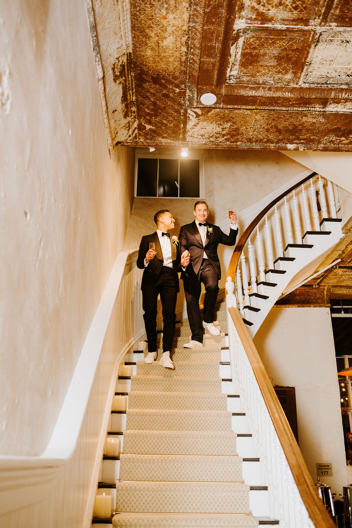 Modern black tie industrial wedding in Amish country two grooms blue tux black tux bow ties eco-friendly staircase