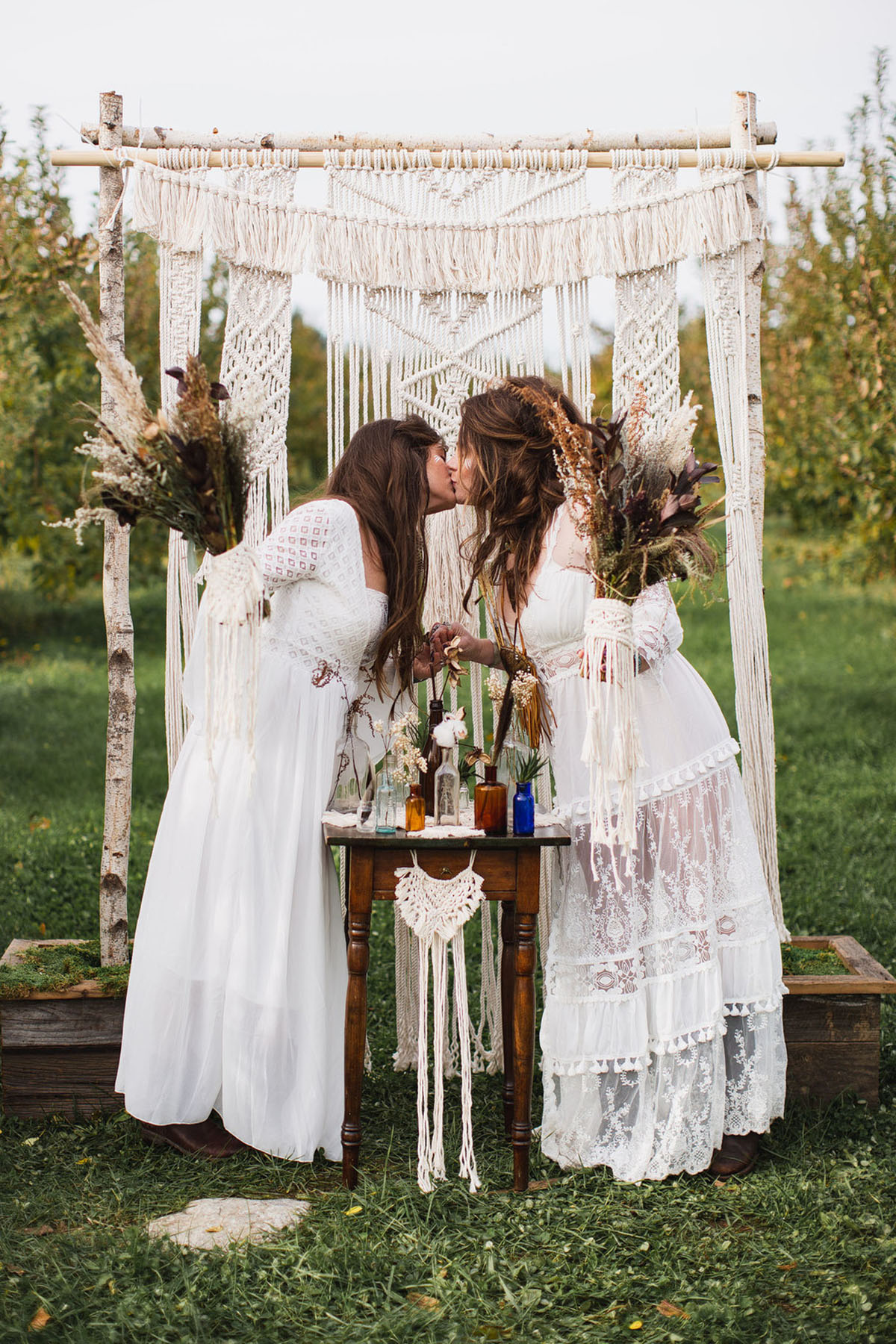 Southwestern garden wedding inspiration macrame dramatic garden of Eve creative lesbian same-sex wedding flower crown kiss