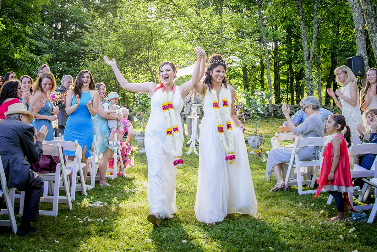 Colorful DIY wedding in the Catskills two brides long white dresses floral wreaths David's Bridal BHLDN
