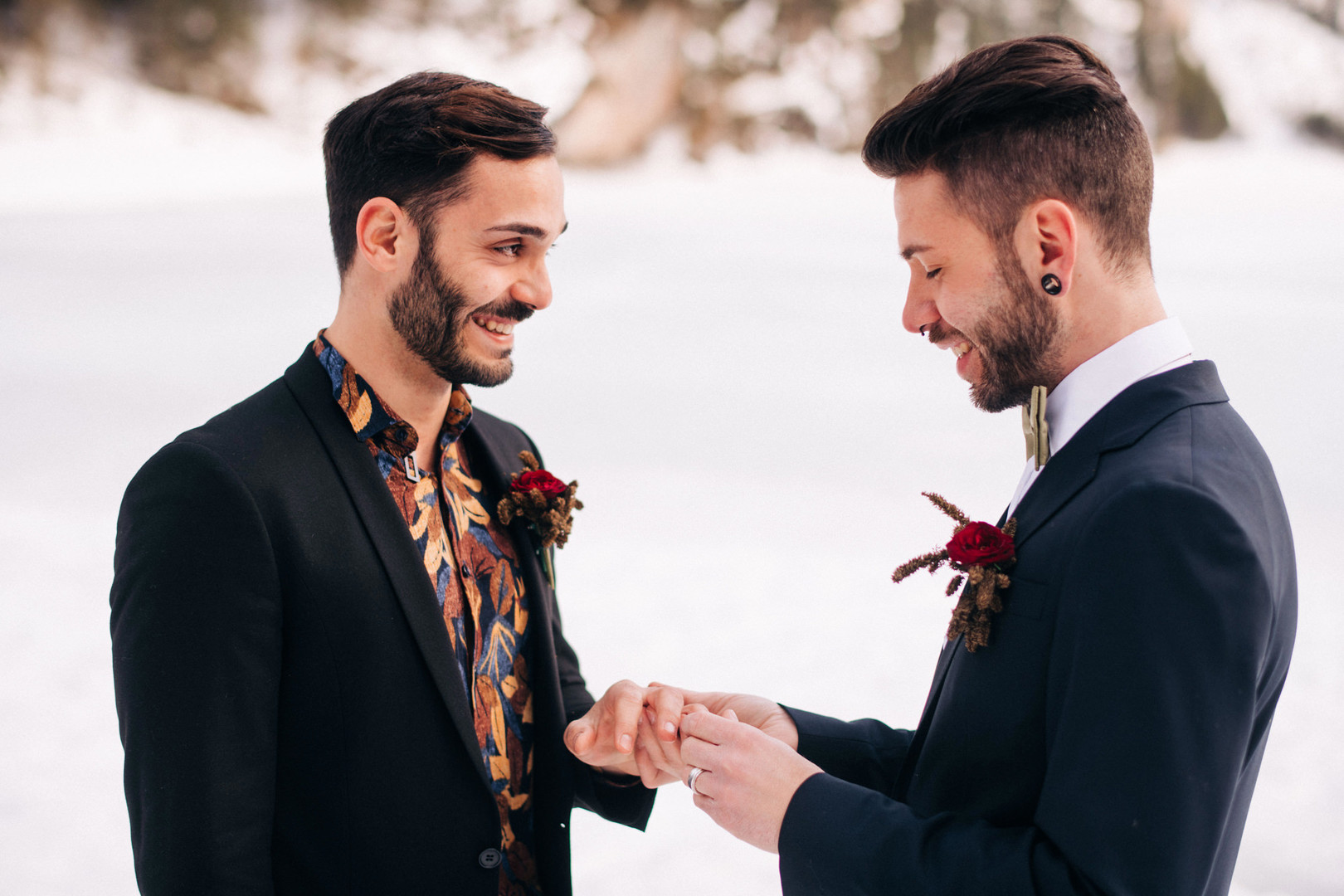 This winter mountain elopement on the Dolomites in Italy is seriously cozy two grooms black tuxedos tux snowy March mountains Lake Braies rings