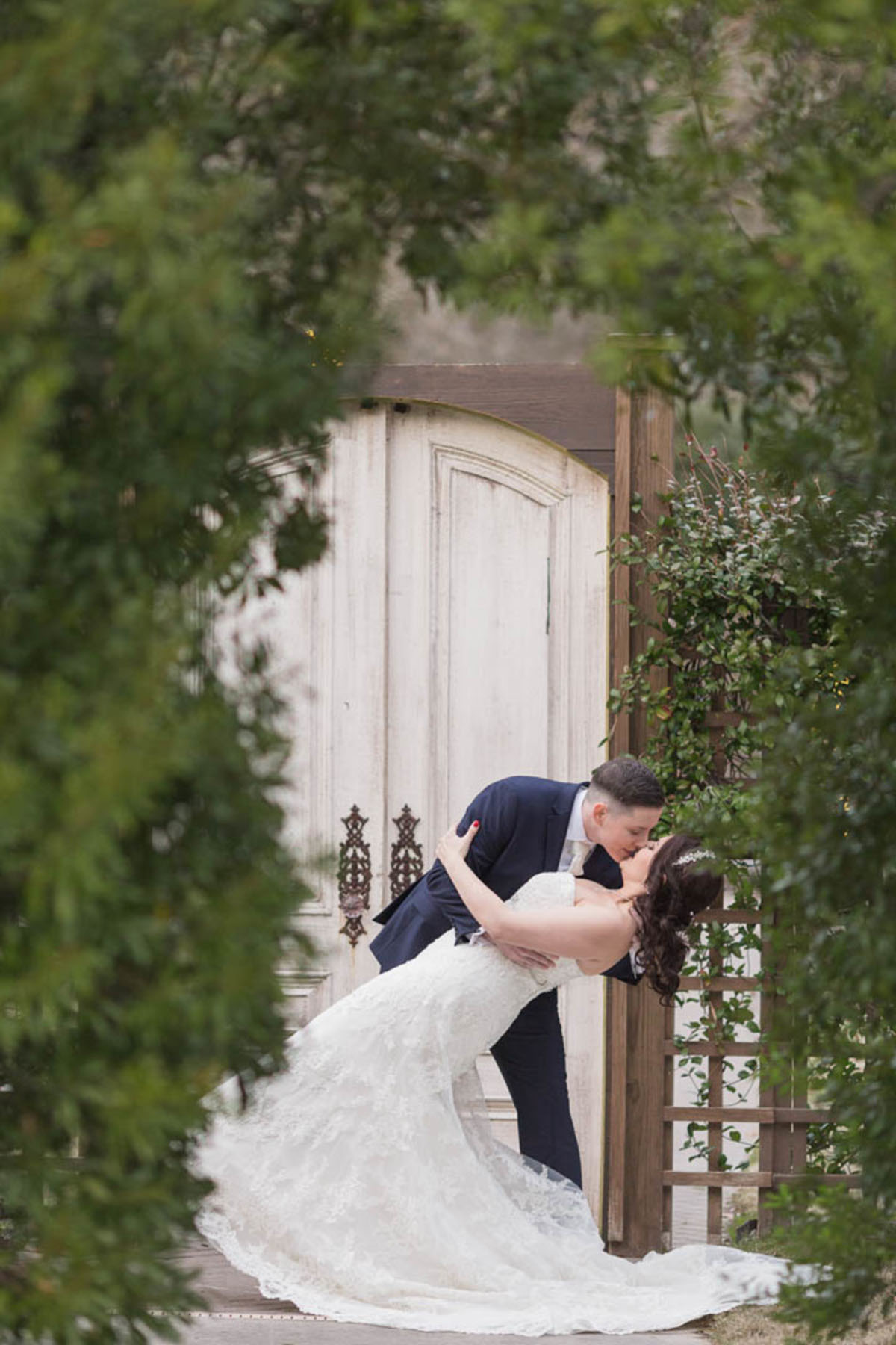 Elegant southern church wedding in Conroe, Texas two brides winter wedding kiss