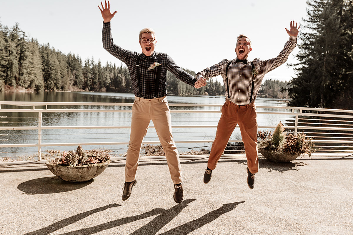 Iridescent bohemian wedding inspiration for the nature lover two grooms gingham plaid suspenders waterfront jump