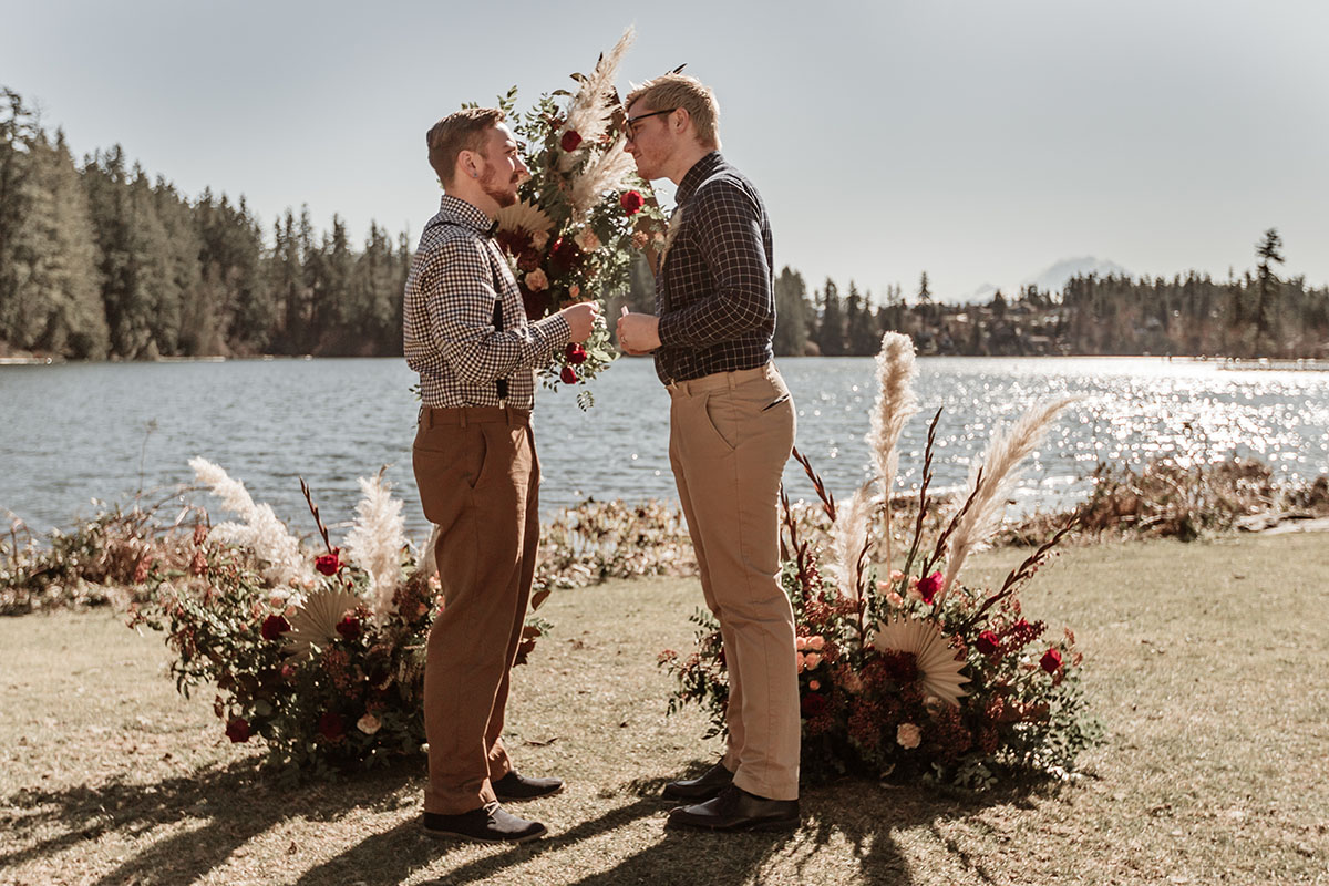 Iridescent bohemian wedding inspiration for the nature lover two grooms gingham plaid suspenders waterfront