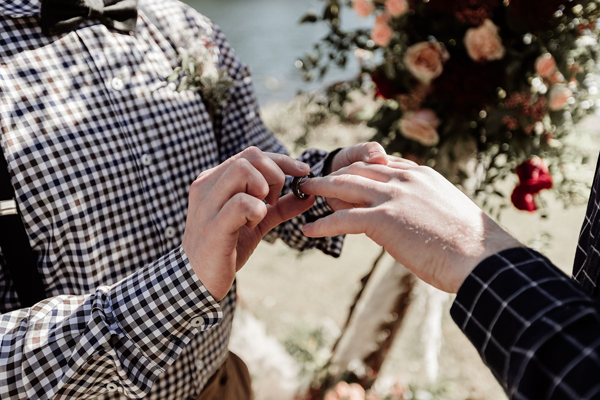 Iridescent bohemian wedding inspiration for the nature lover two grooms gingham plaid suspenders waterfront rings
